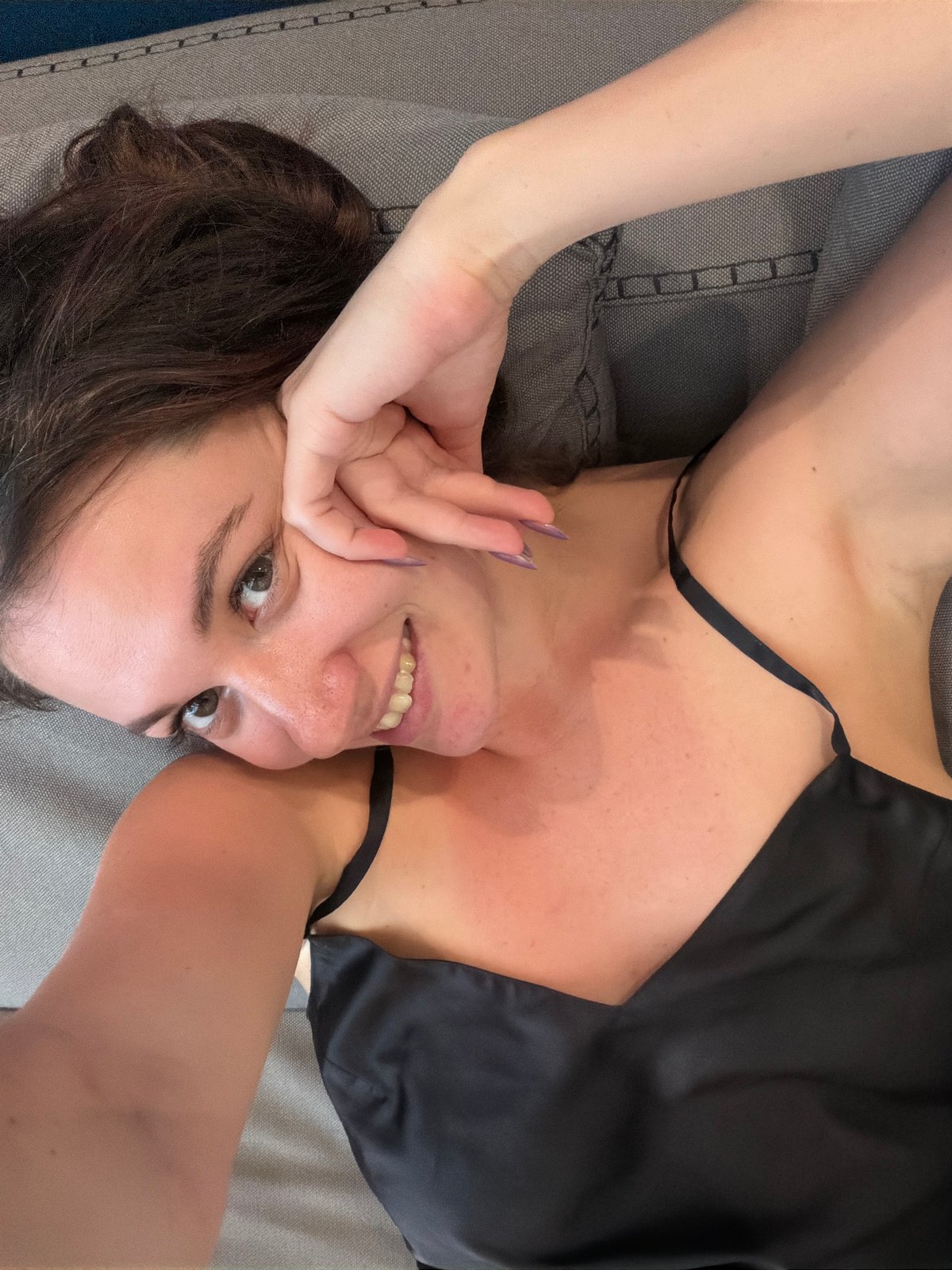 Woman observed resting on grey surface in Athens