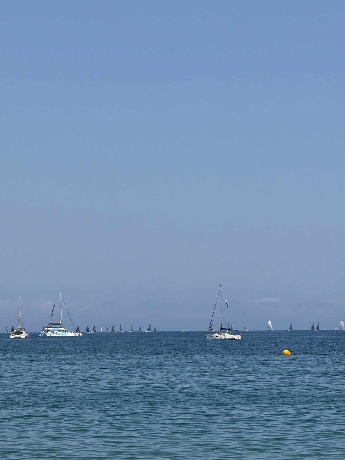 Barcelona coastal activities include sailing regatta and beach scenes
