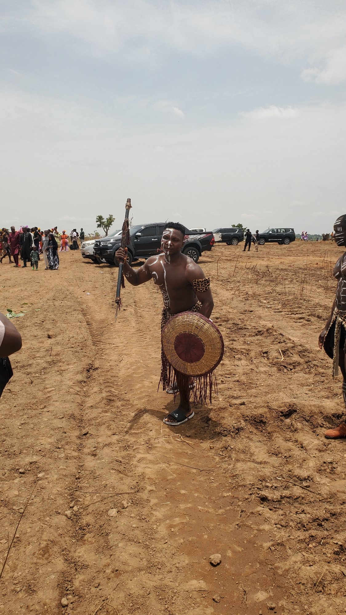 Four men pose with traditional paint, leopard print in Akwanga