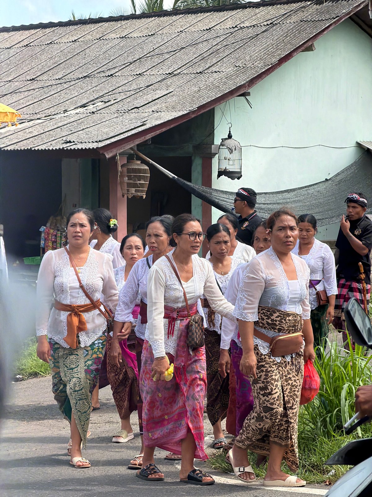 Traditional procession moves through sunny Tampaksiring streets