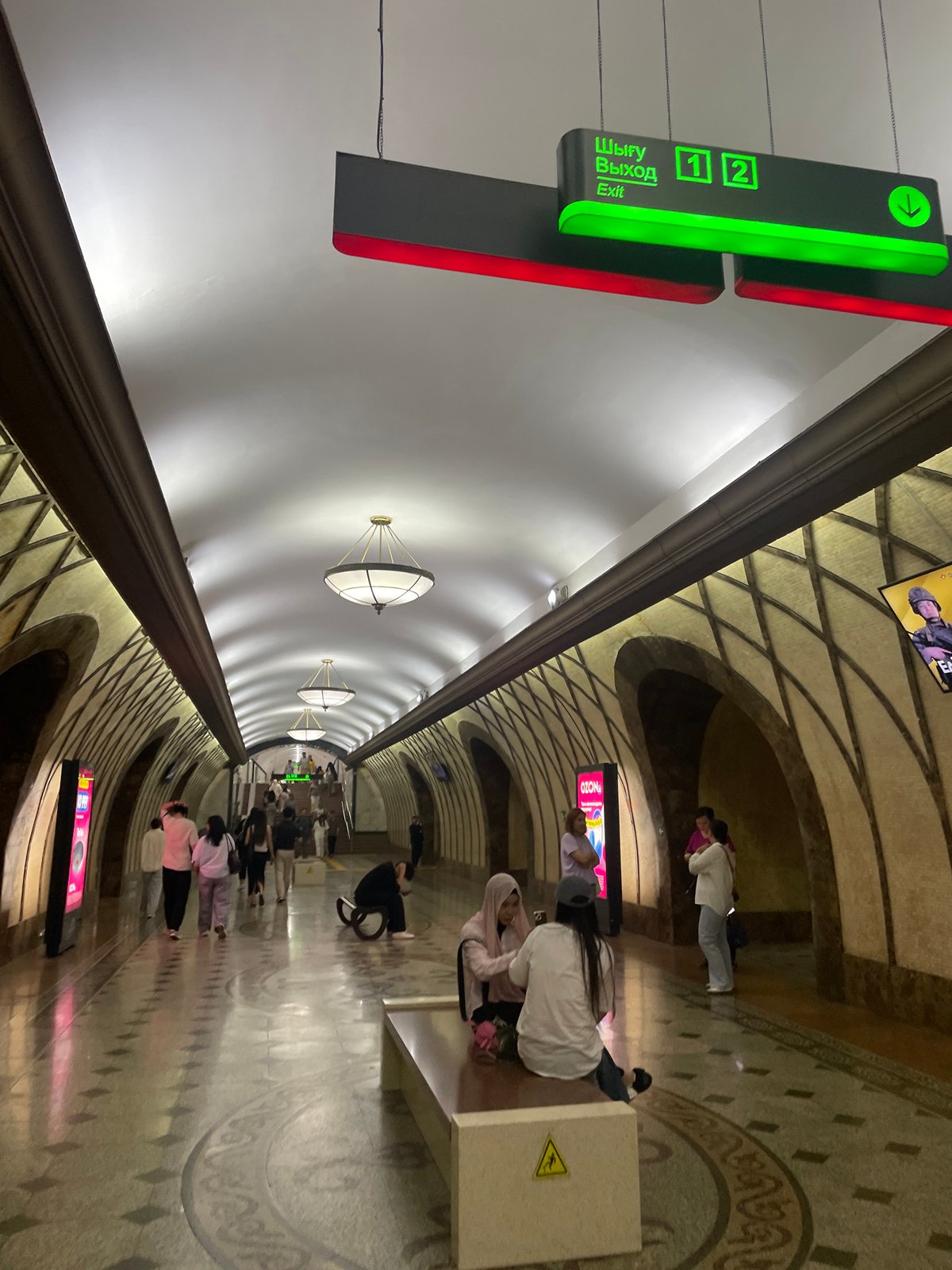 Almaty streets, metro stations, and a late-afternoon soccer game