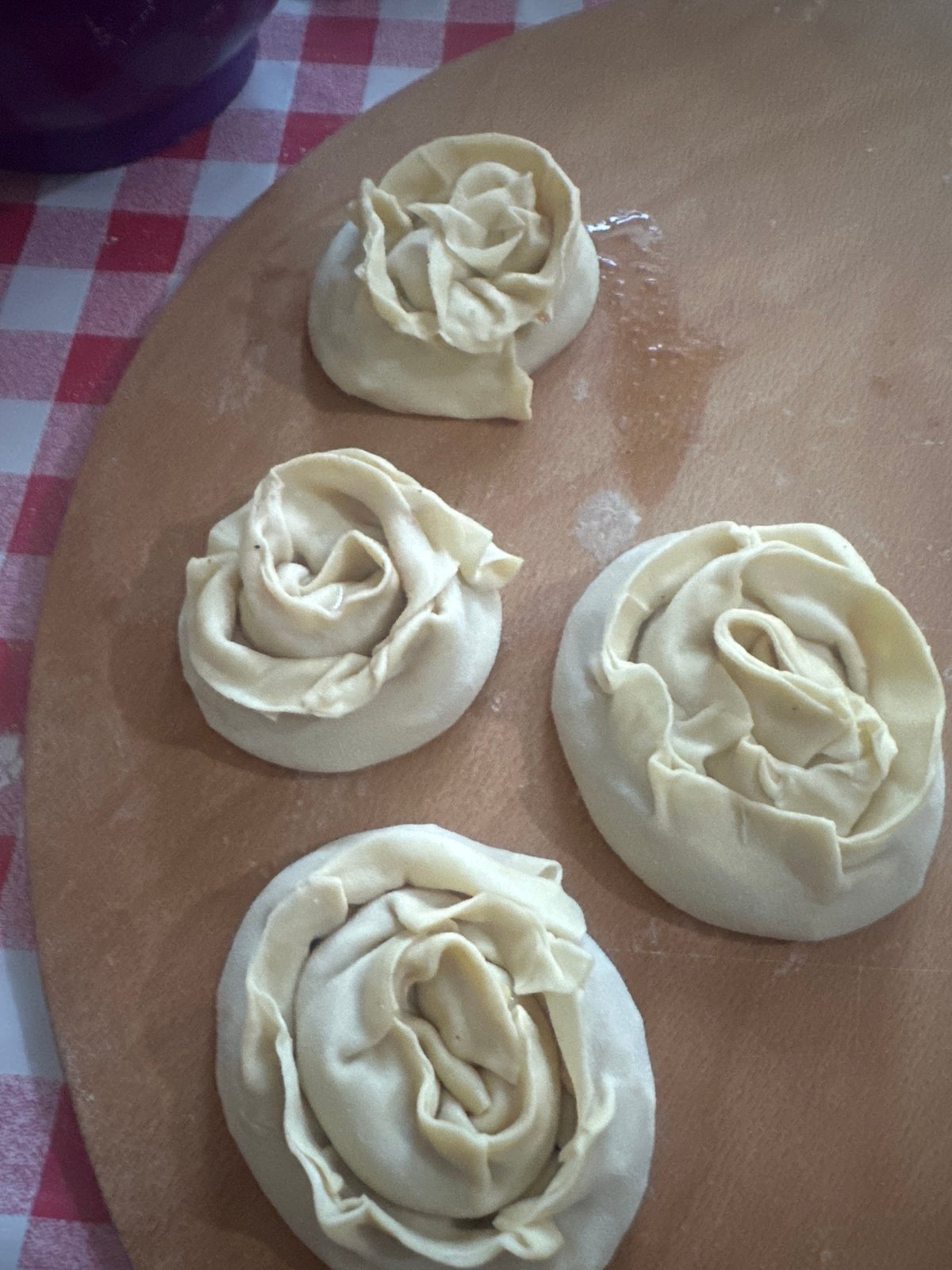 Rose-shaped pastry doughs lined up and ready to bake