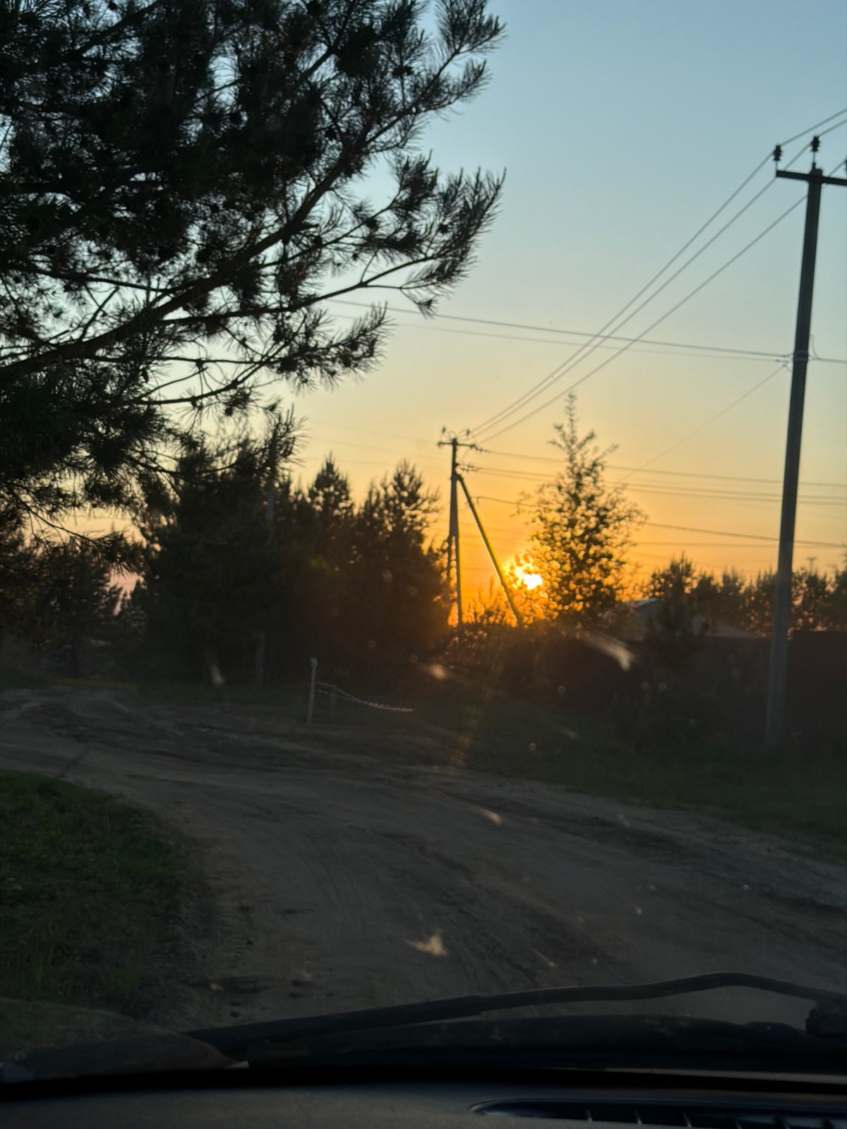 Woman enjoys sunset beer break on rural Russian roadside