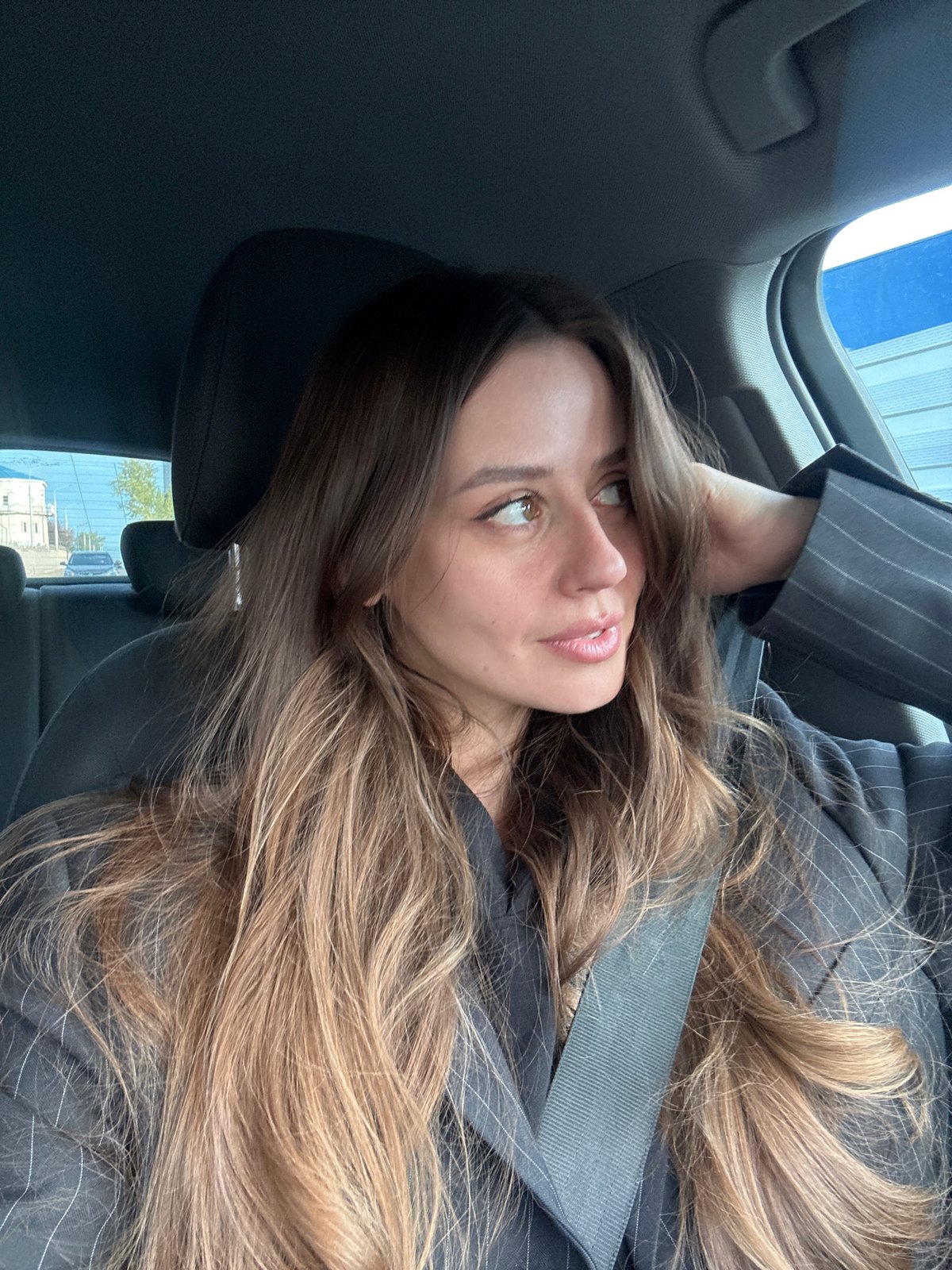 Woman in business attire observed in car in Krasnoyarsk