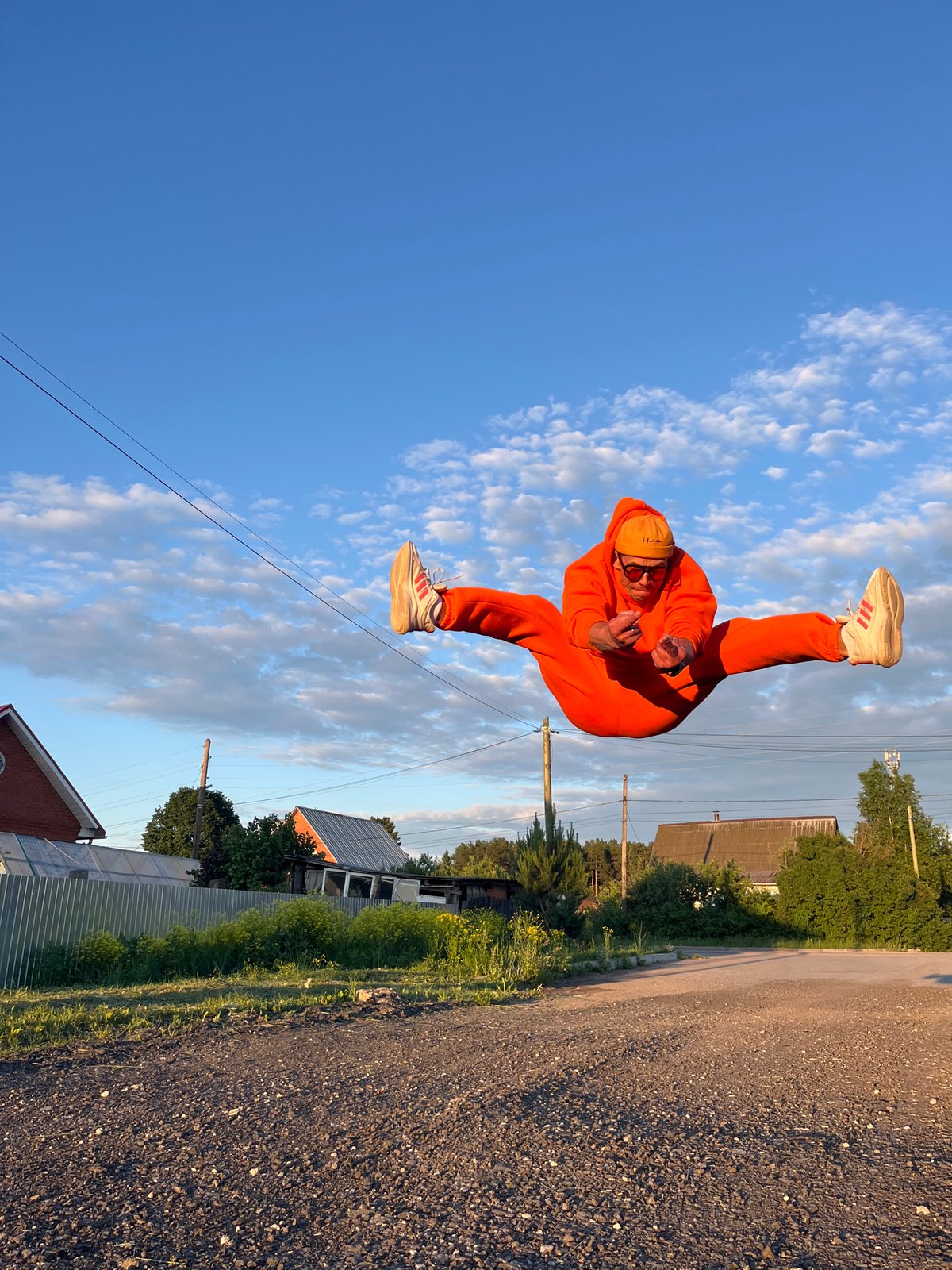 Orange tracksuit photoshoot with child captured in Chaikovsky Russia
