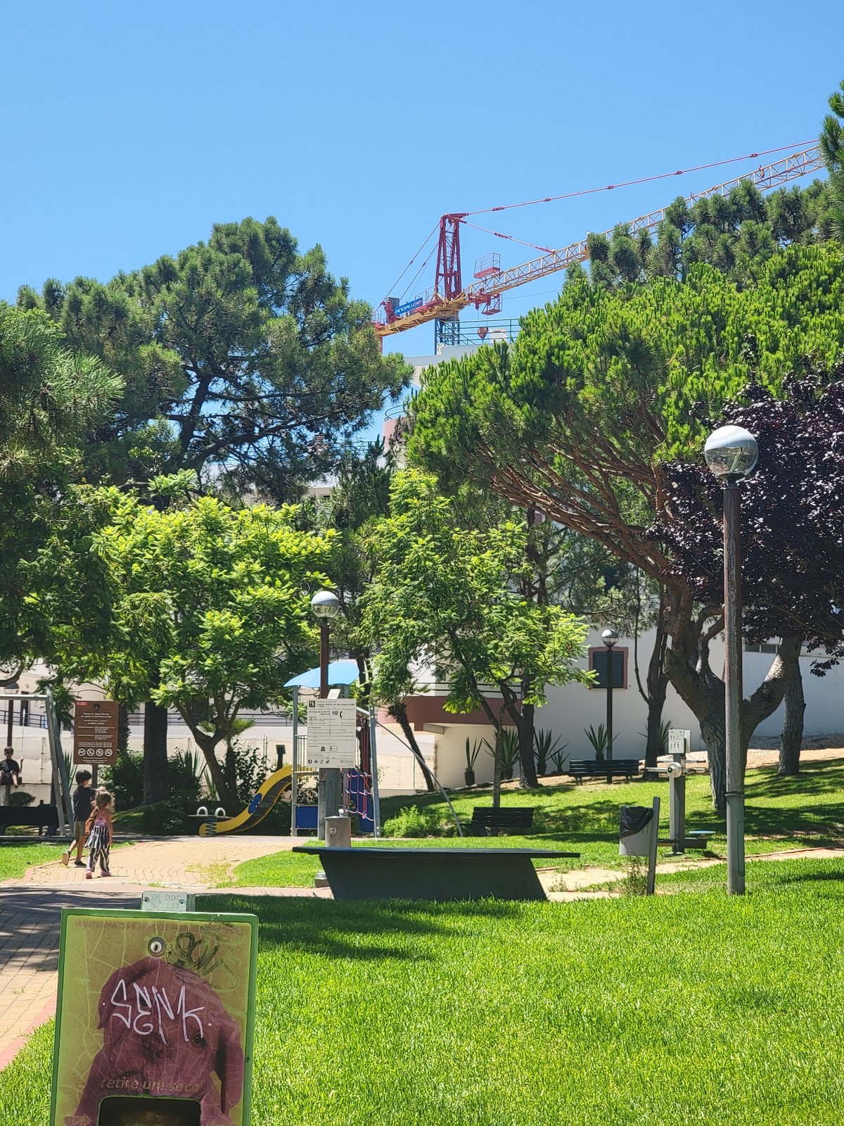 Sunny afternoon stroll through Quarteira's streets and park