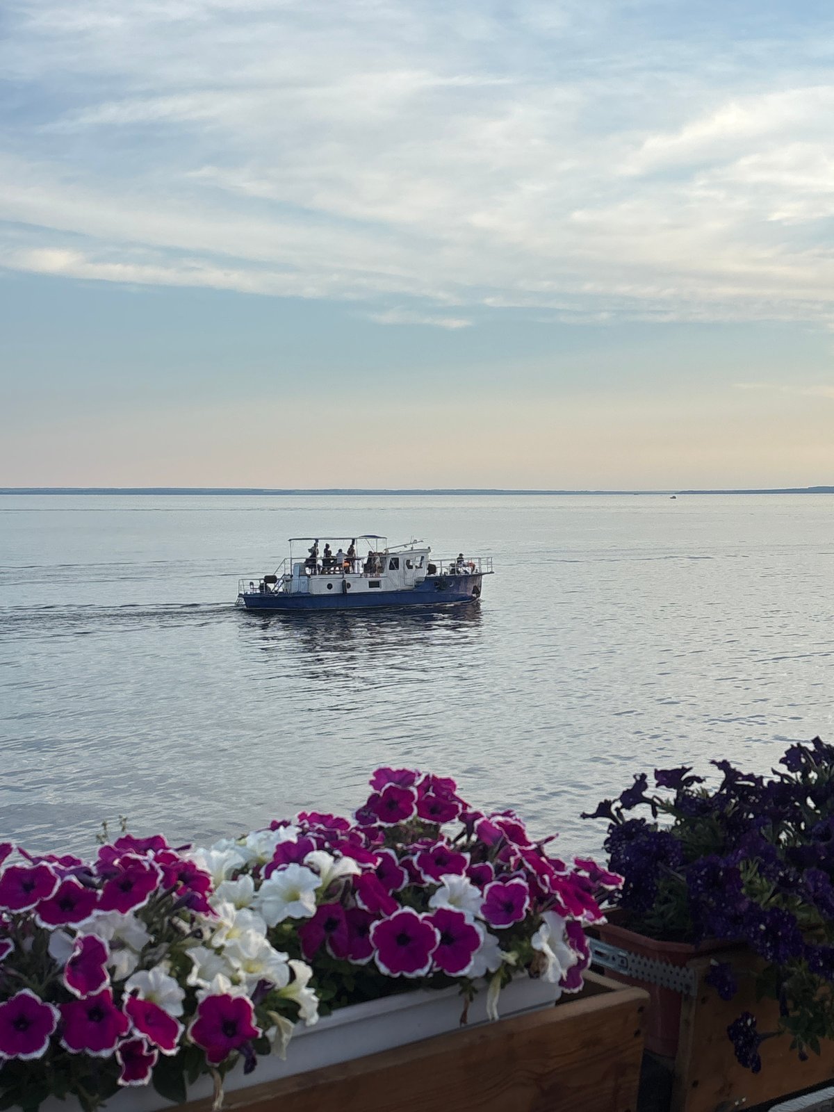 Tolyatti riverfront at golden hour, boats and blooms