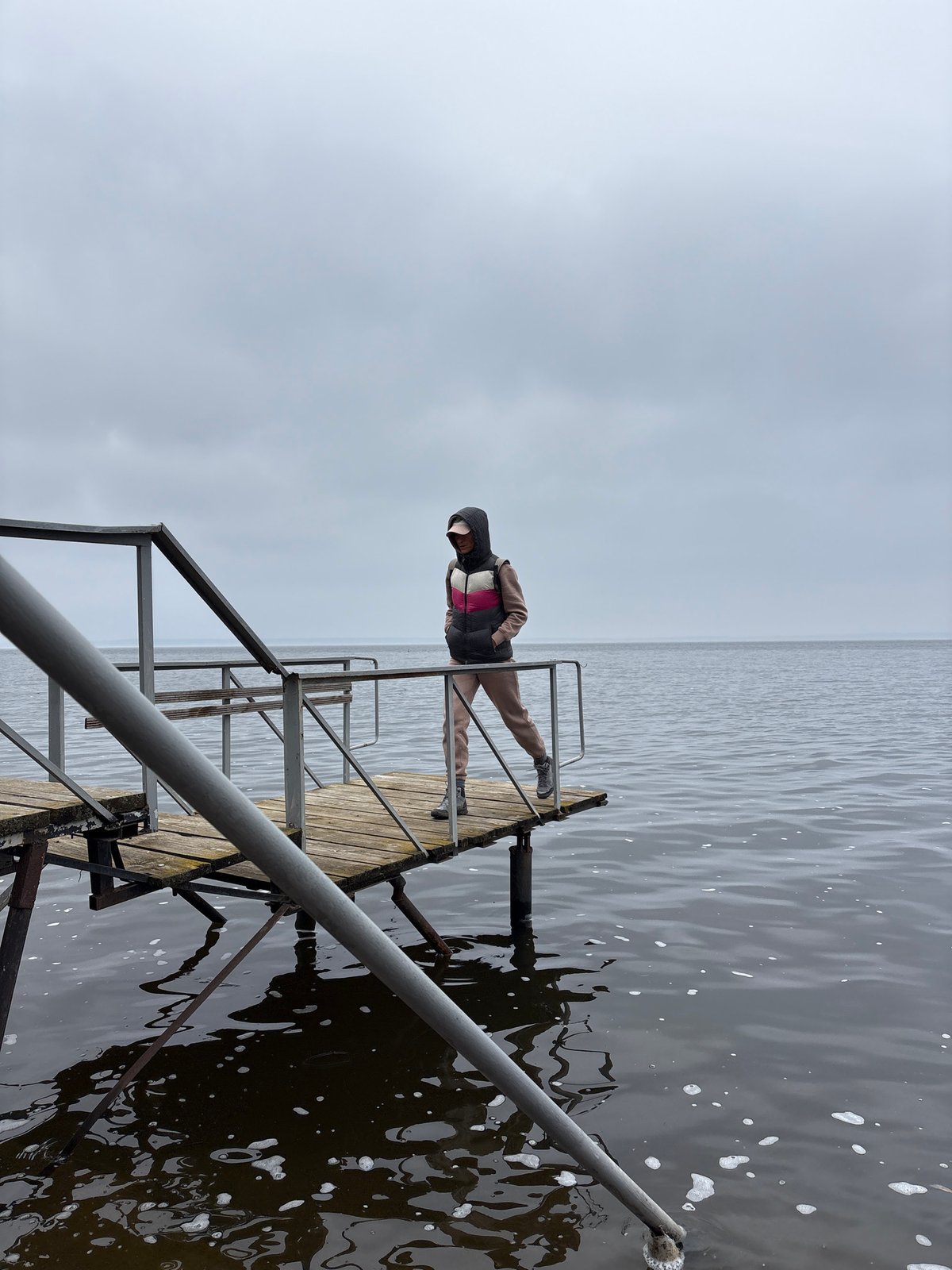 Person sits on pier edge in Ulyanovsk, Russia