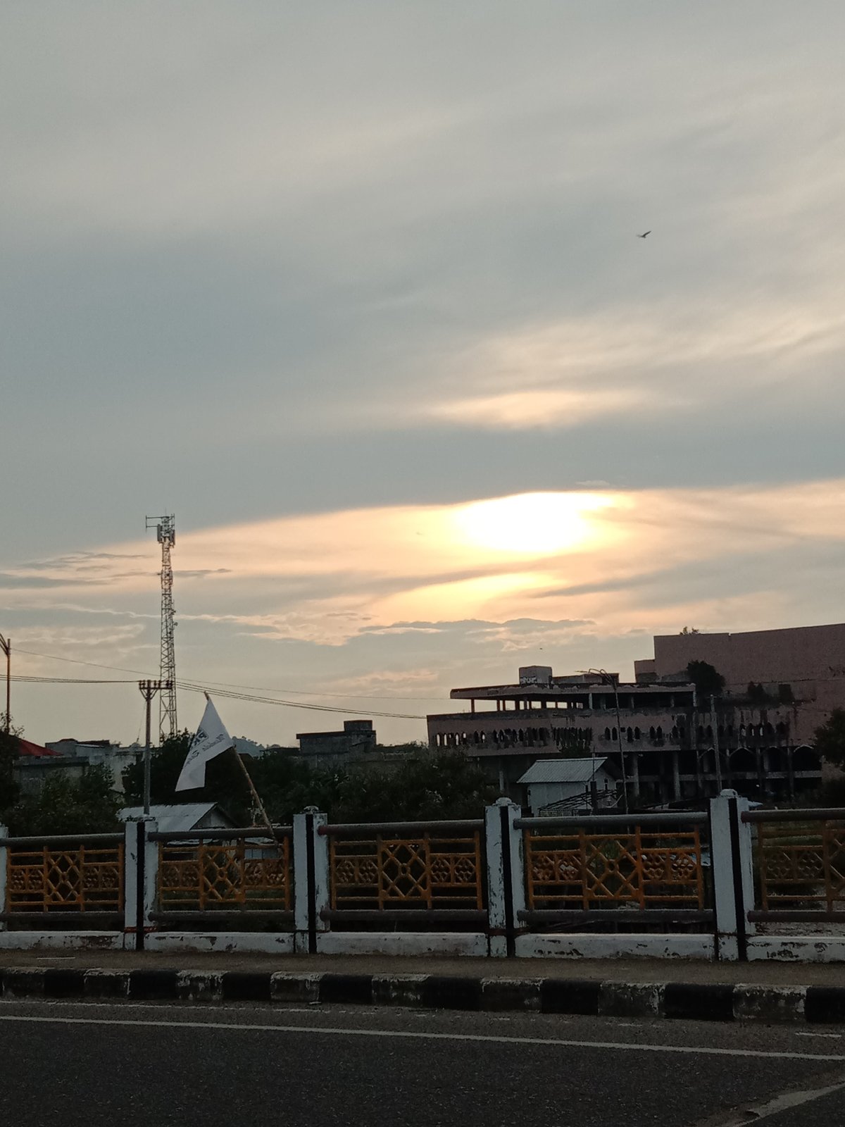 Bridge observer documents evening traffic in Lhokseumawe, Indonesia