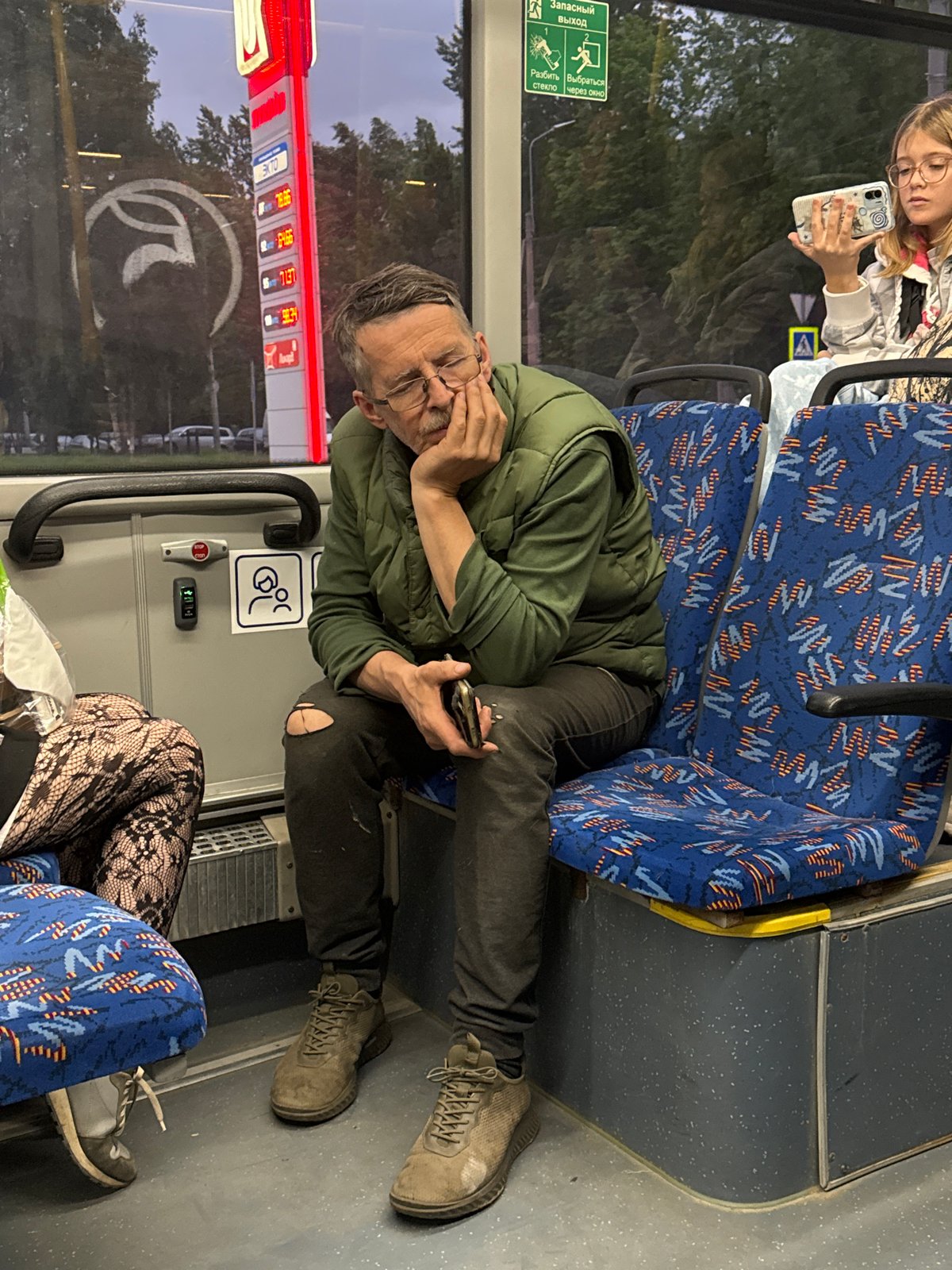 Man with smartphone rides bus in Saint Petersburg