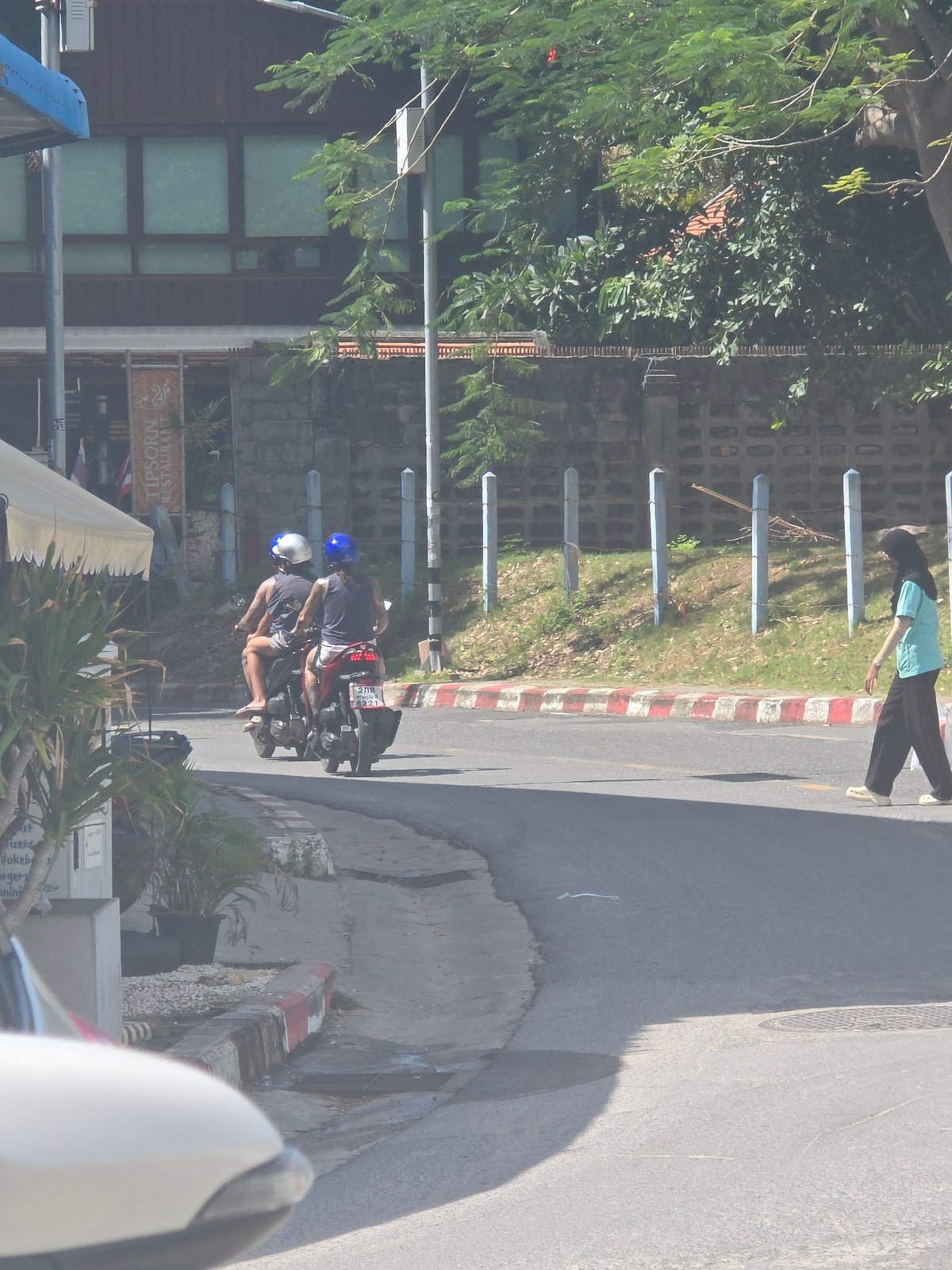 Tropical street life: scooters, trucks, and sidewalk scenes midmorning