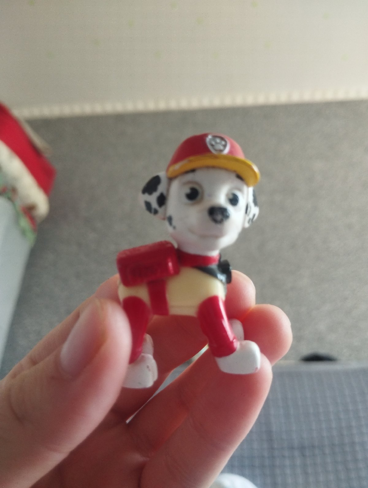Spotted toy firefighter dog examined up close indoors
