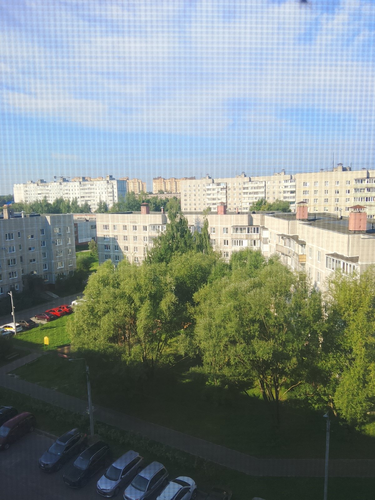 Aerial look at Yegoryevsk apartment blocks amid green trees
