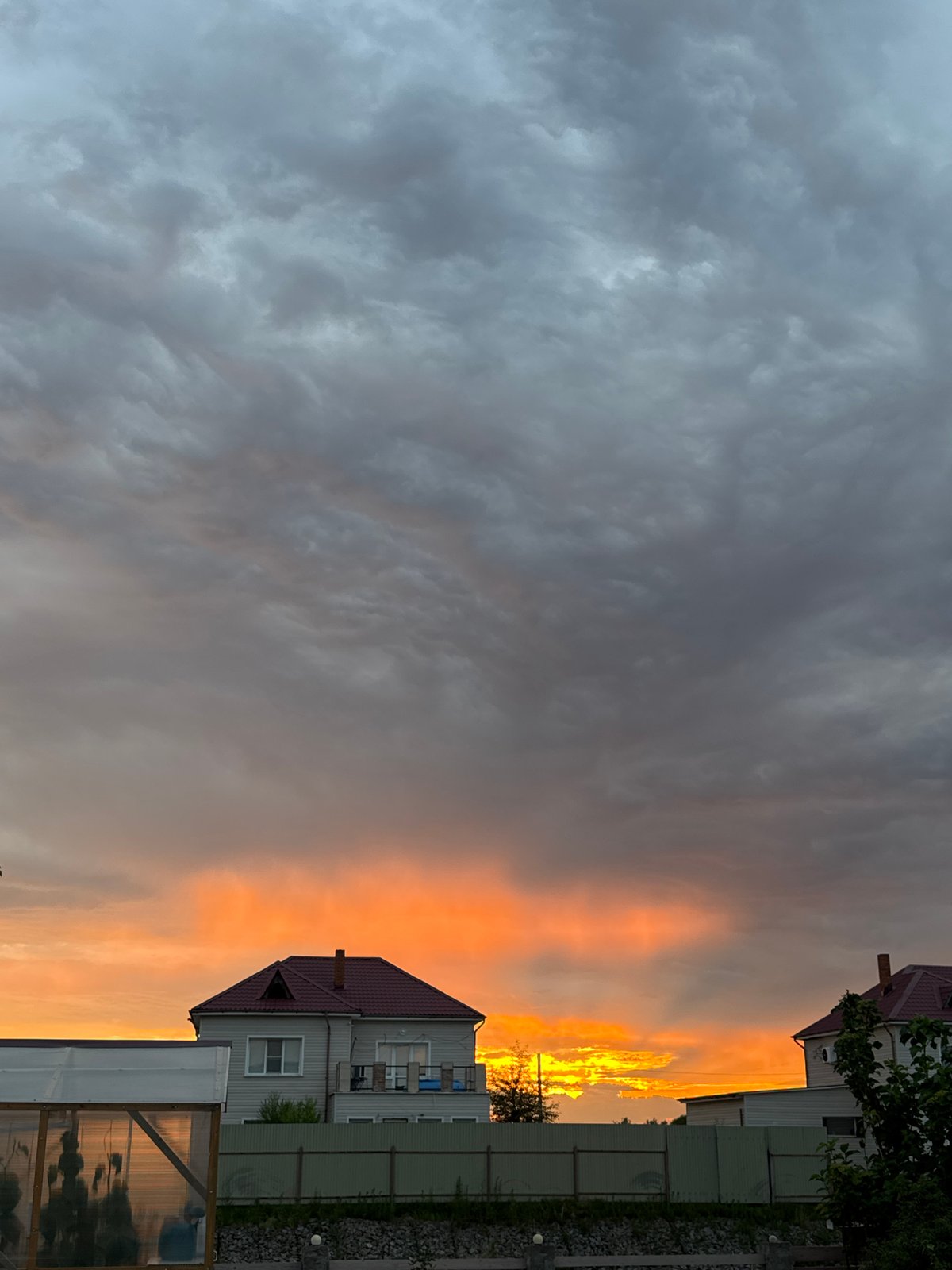 Stormy sunset sky over rural Michurinskoye, Russia