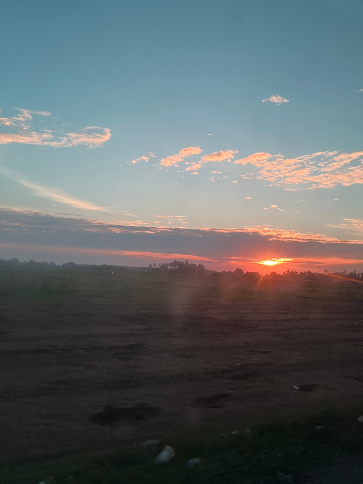 Golden hour skies over Meunasah Pupu, sun low on the horizon