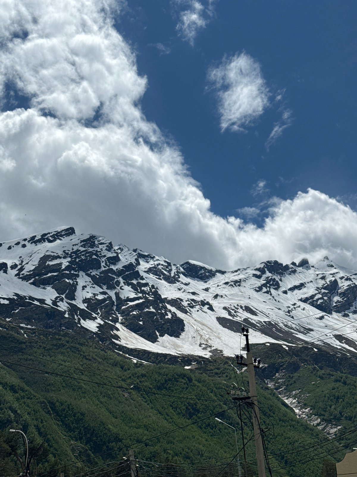 Snow-capped peaks and village paths in Terskol's Caucasus landscape