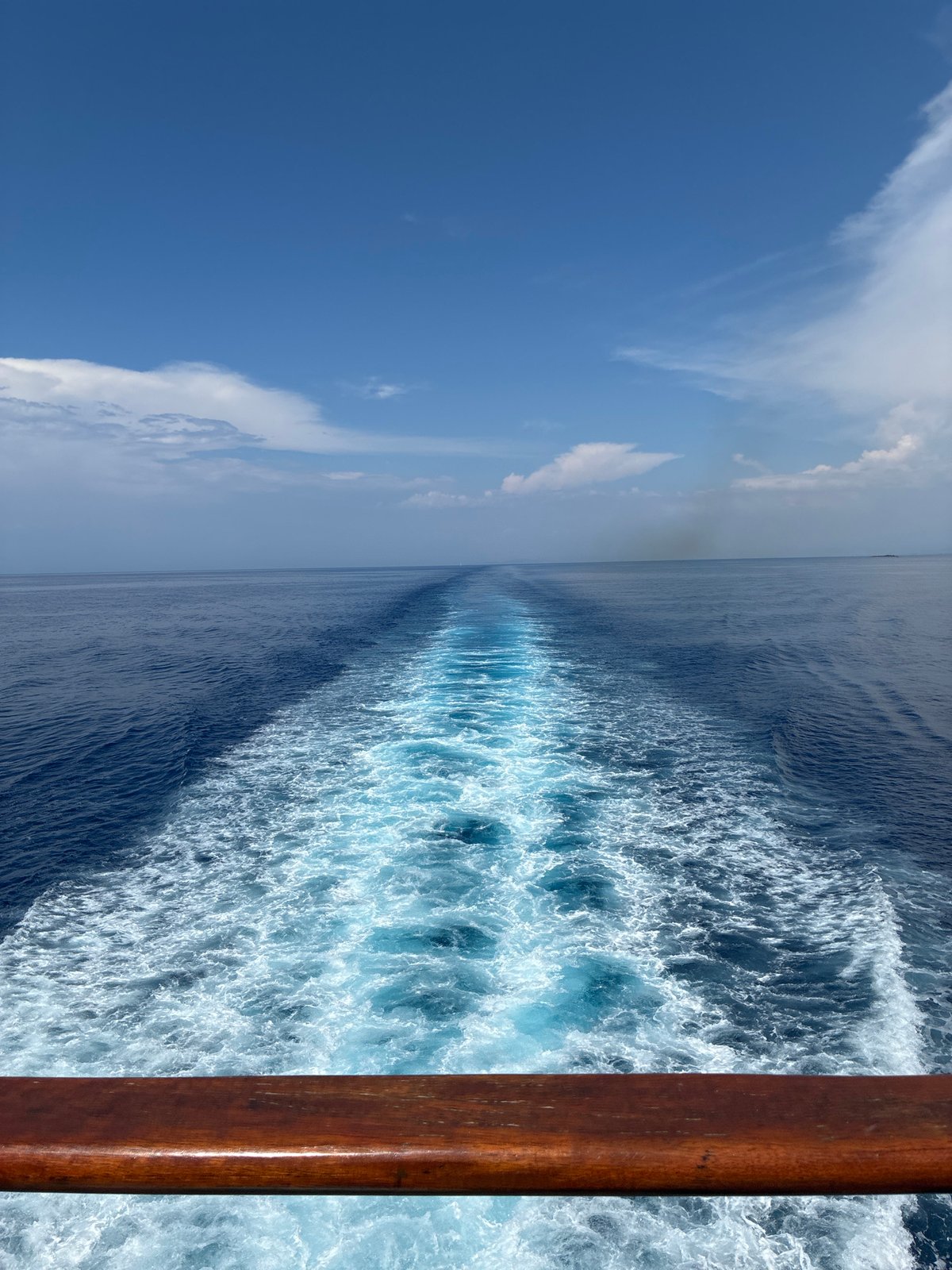 Boat wake cutting through blue Ionian water near Kafkalida