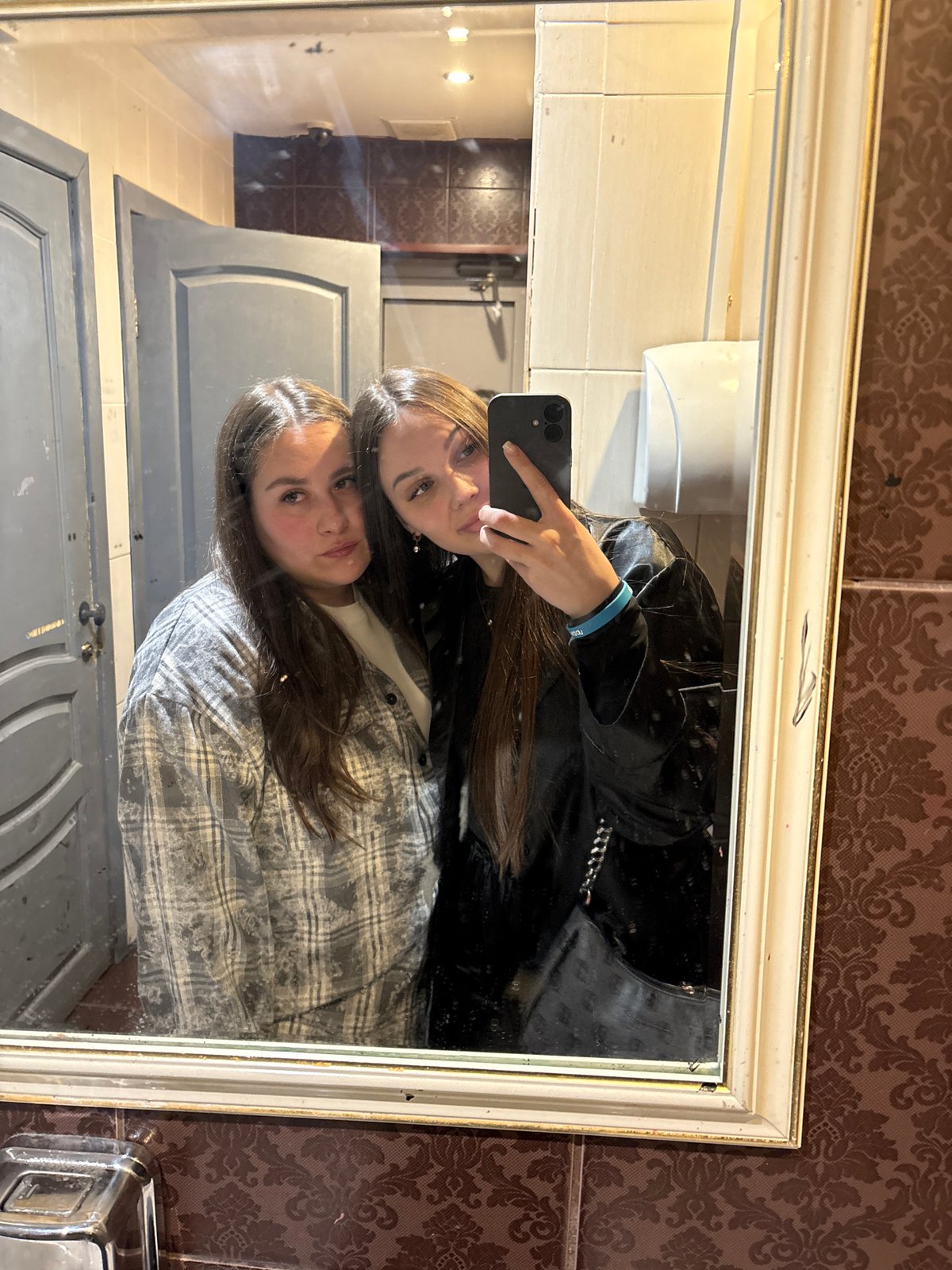 Two women take bathroom mirror selfie in Izhevsk