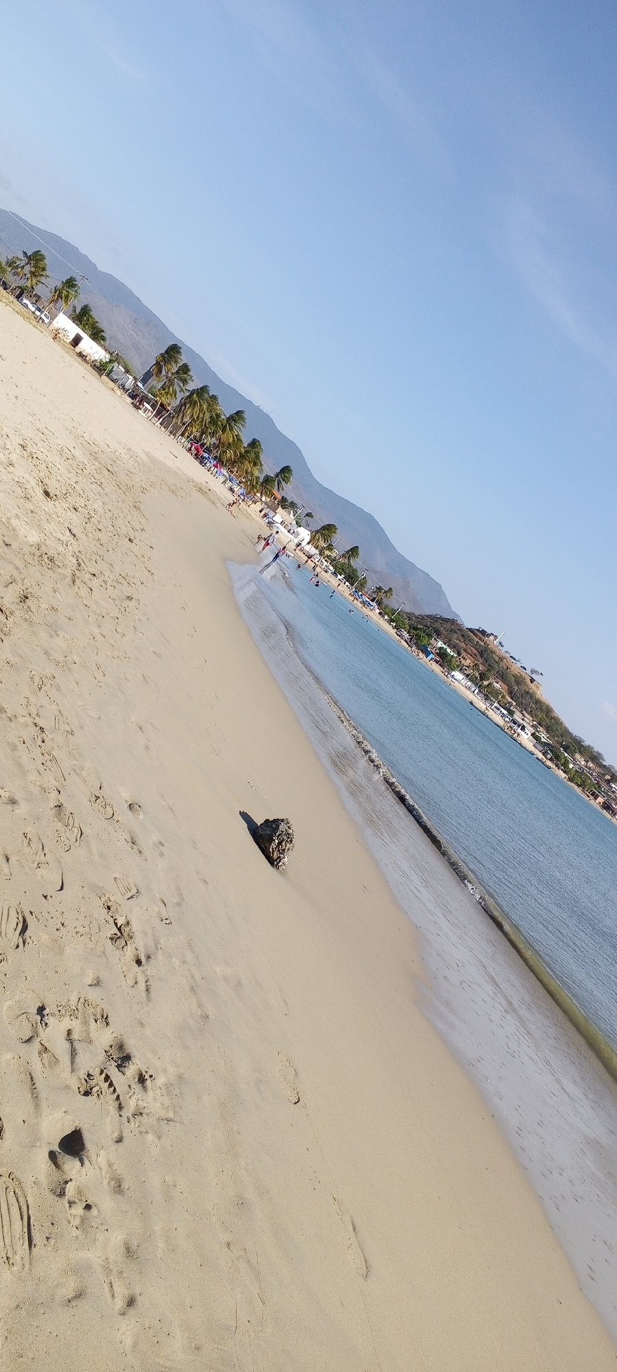 Evening beach gathering with swimming, kites, music system documented