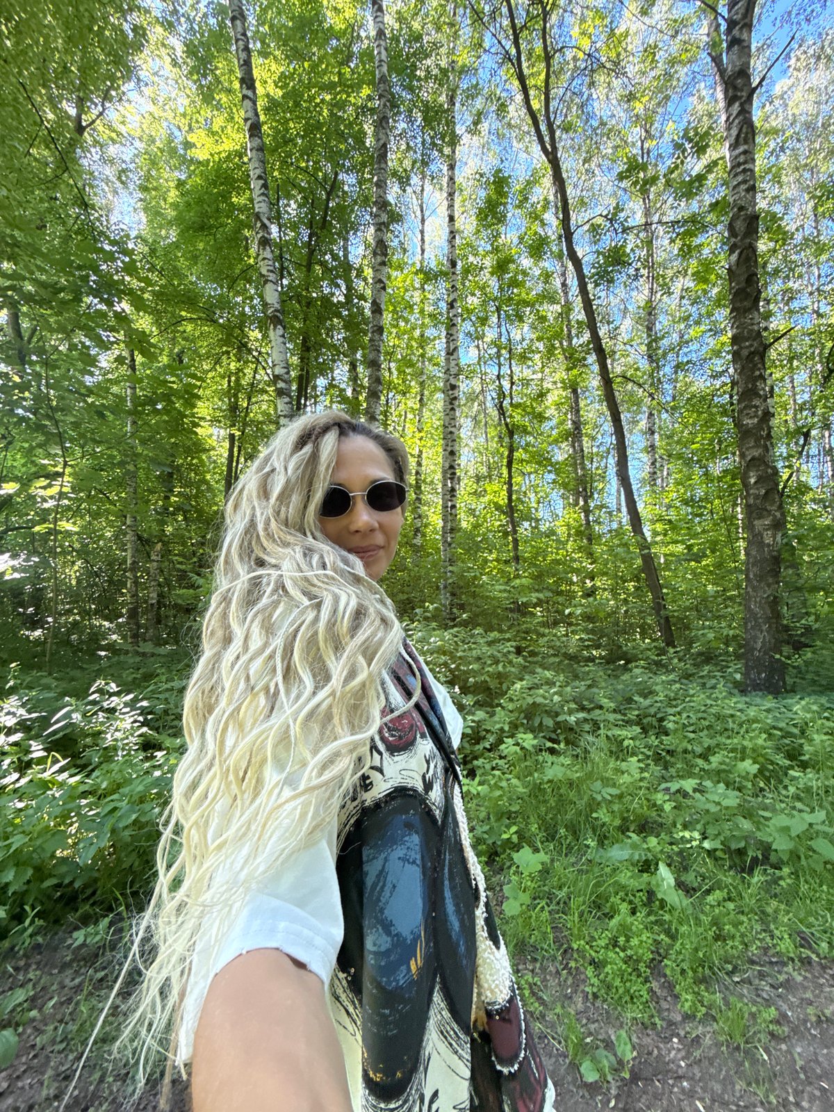 Woman photographed looking back in forest setting
