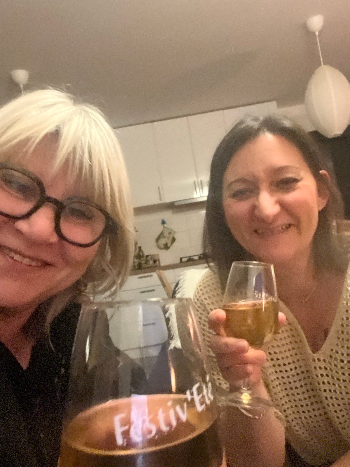 Women share drinks at indoor gathering in Chambœuf