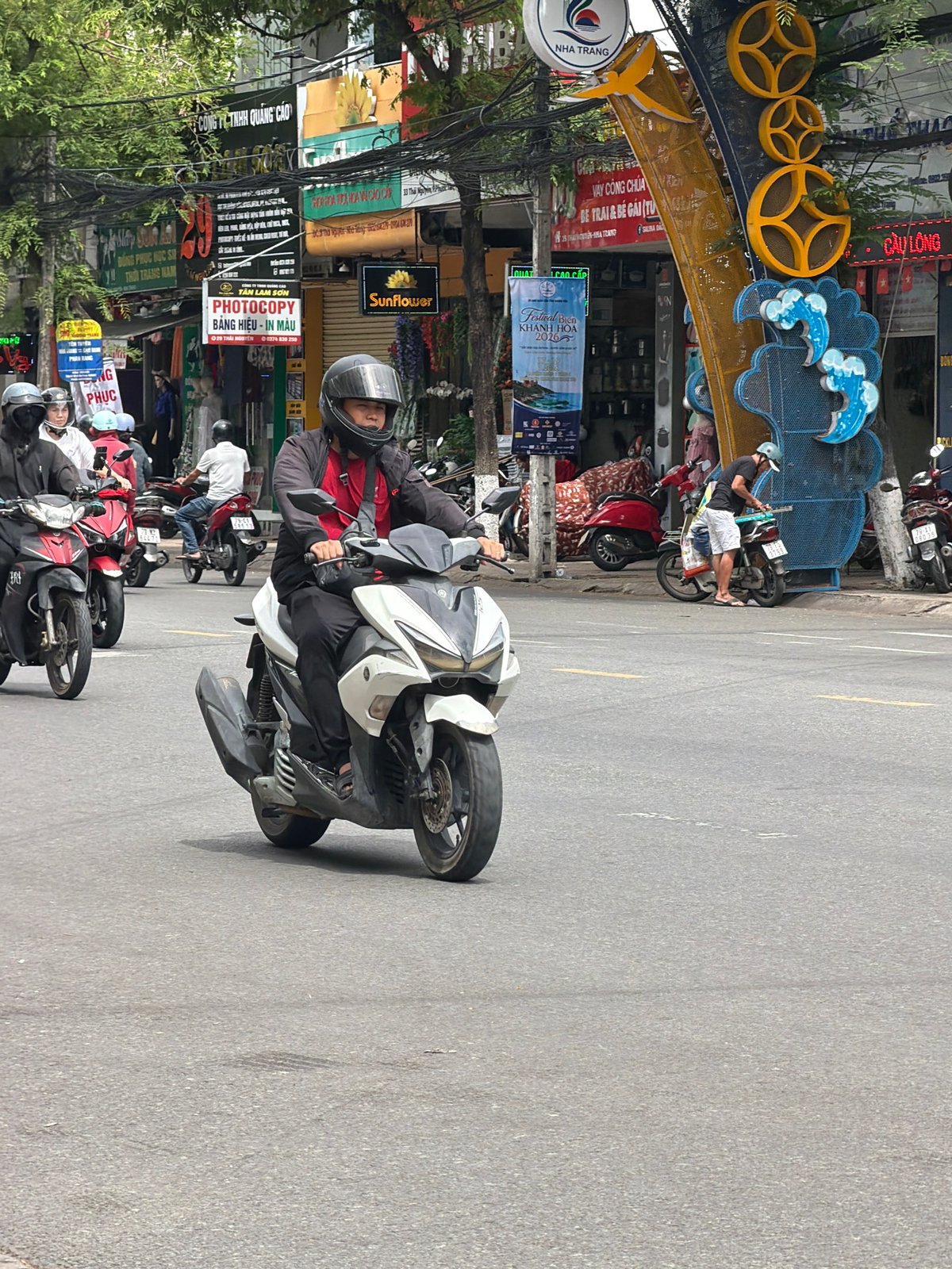 Morning motorcycle traffic flows through central Nha Trang