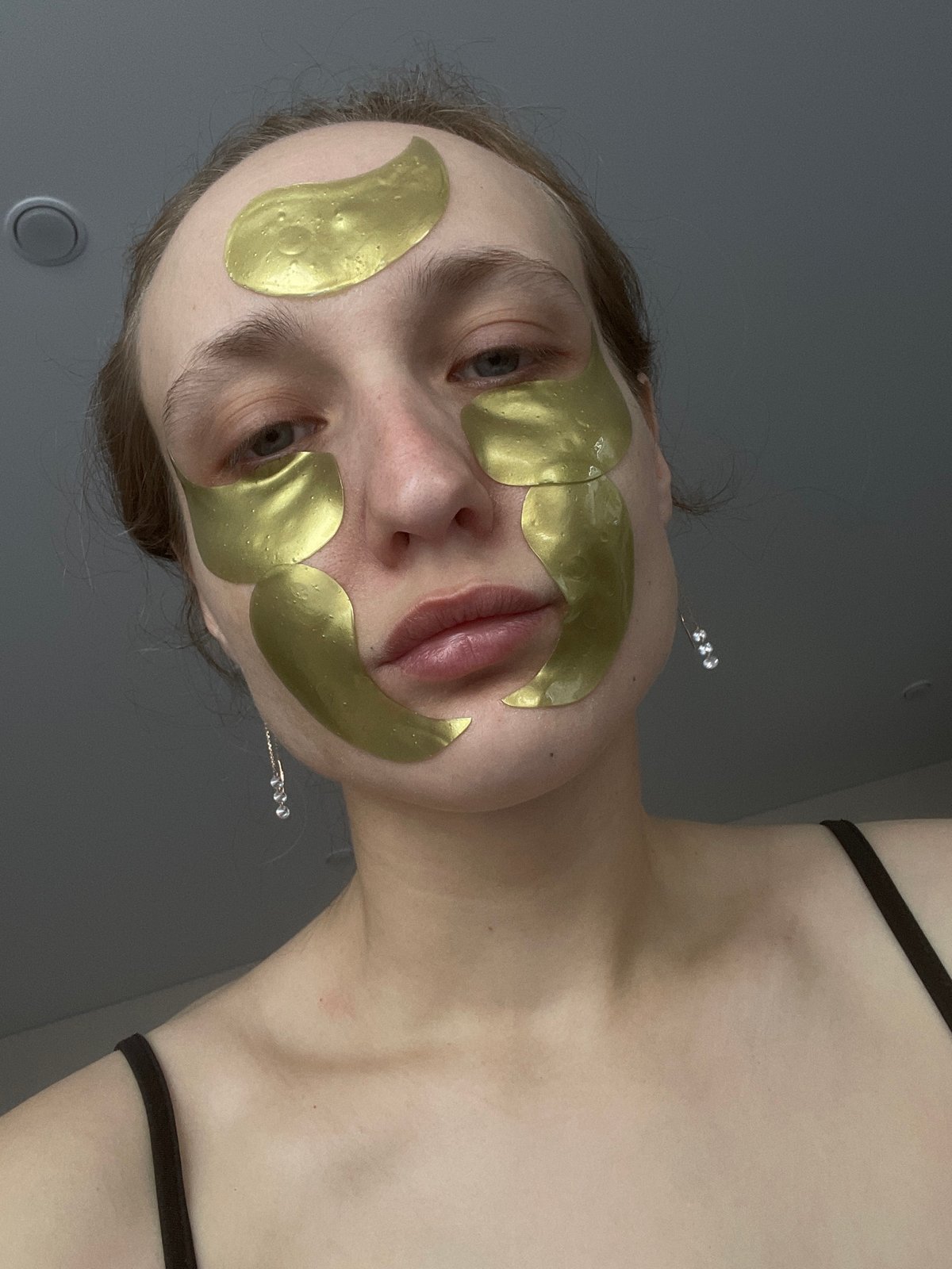 Woman applies gold facial masks in Russian village