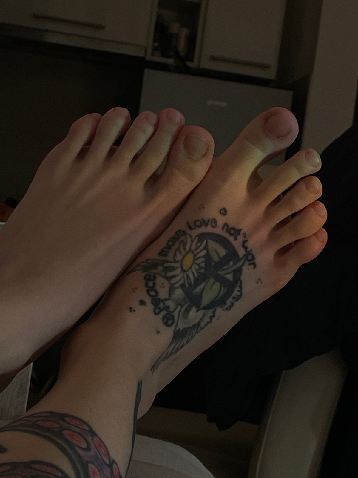 Person with octopus tattoo rests indoors in Belgrade suburb