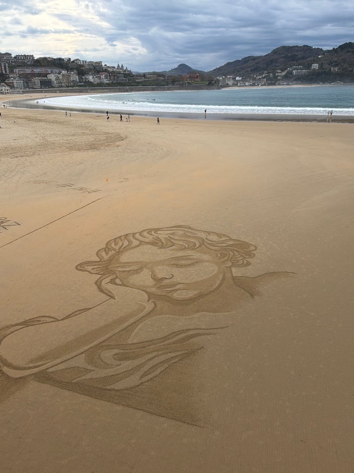 Sand art and scenic views captured at San Sebastián's La Concha Beach