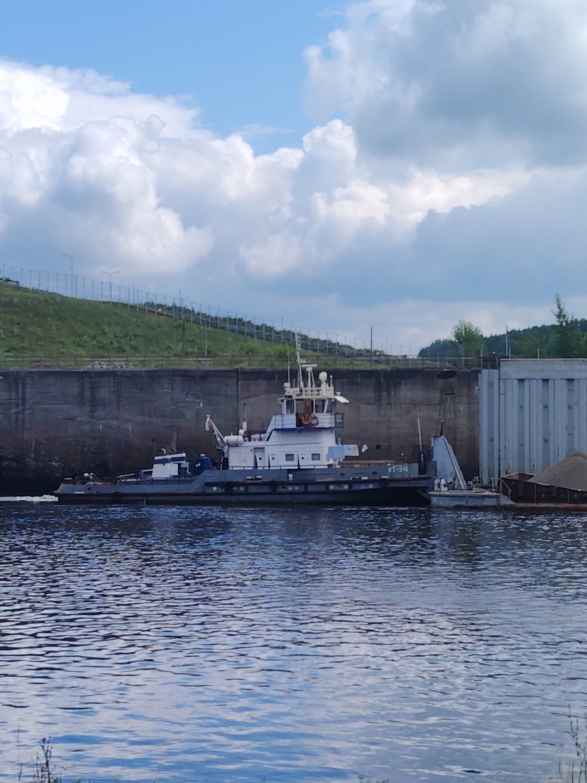 Tugboat PT-318 works the Chaikovsky lock system on a summer morning