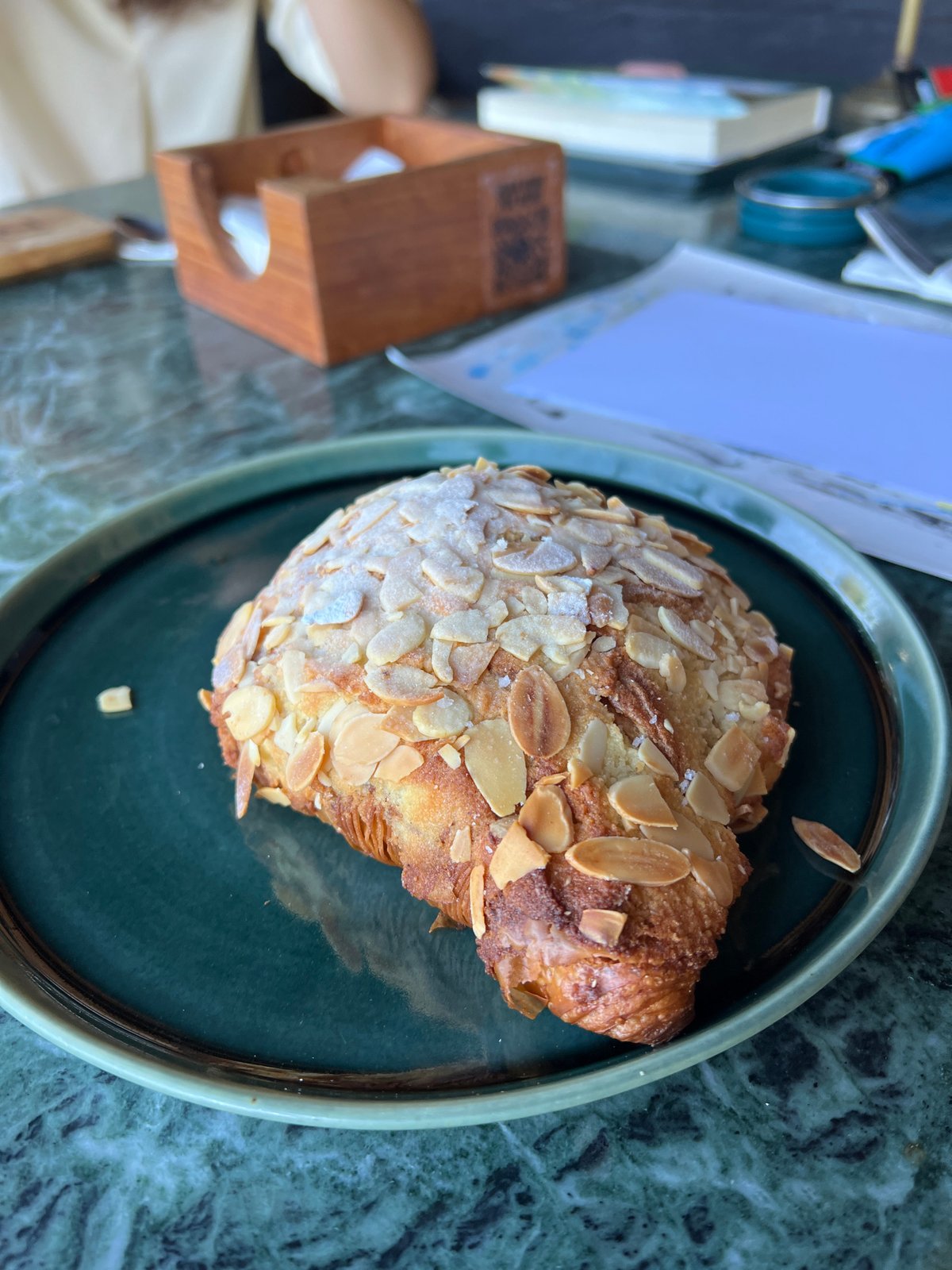 Woman cycles to bakery for croissant in Sukawati