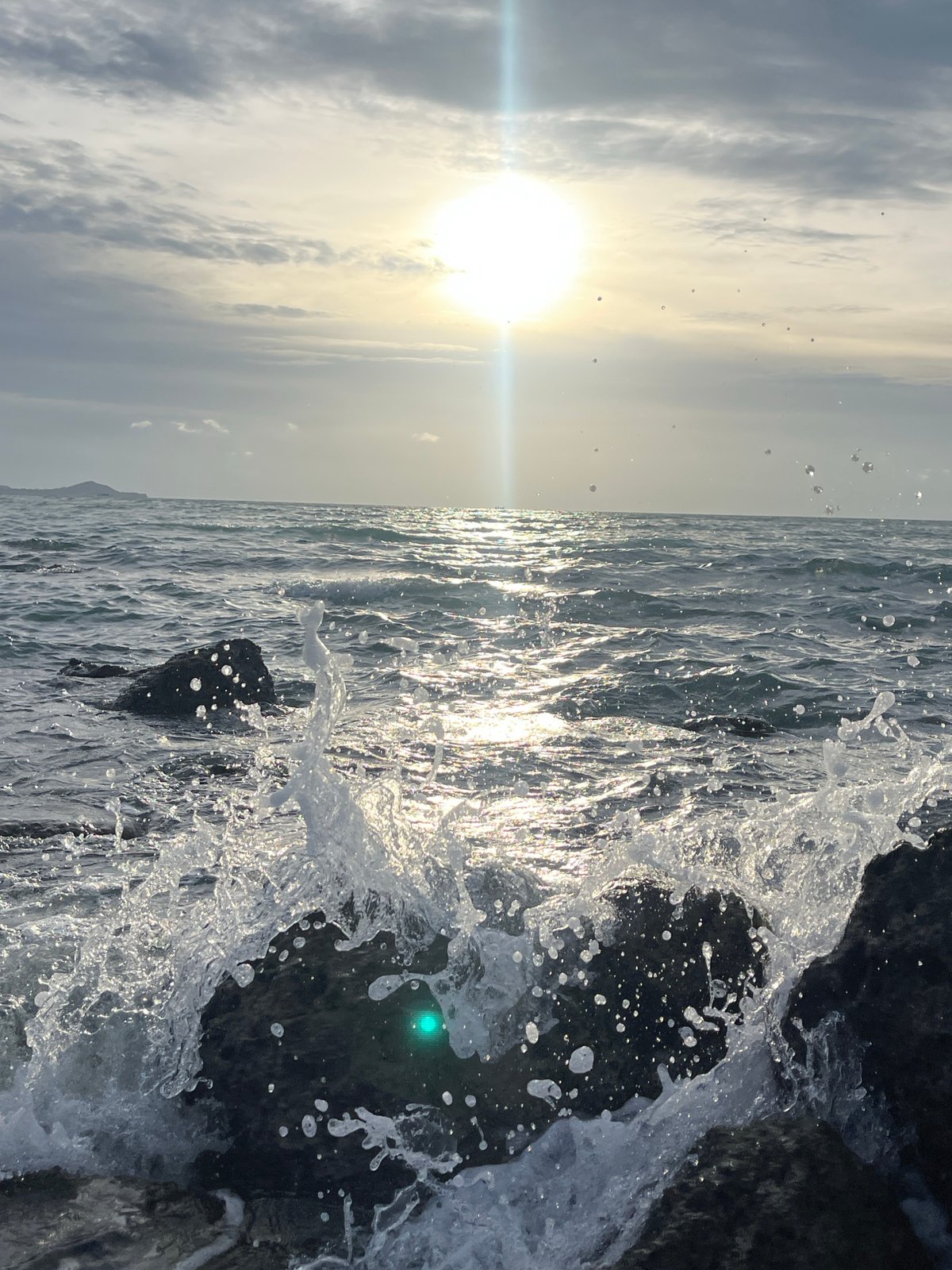 Waves breaking against Ko Samui rocks in bright morning light