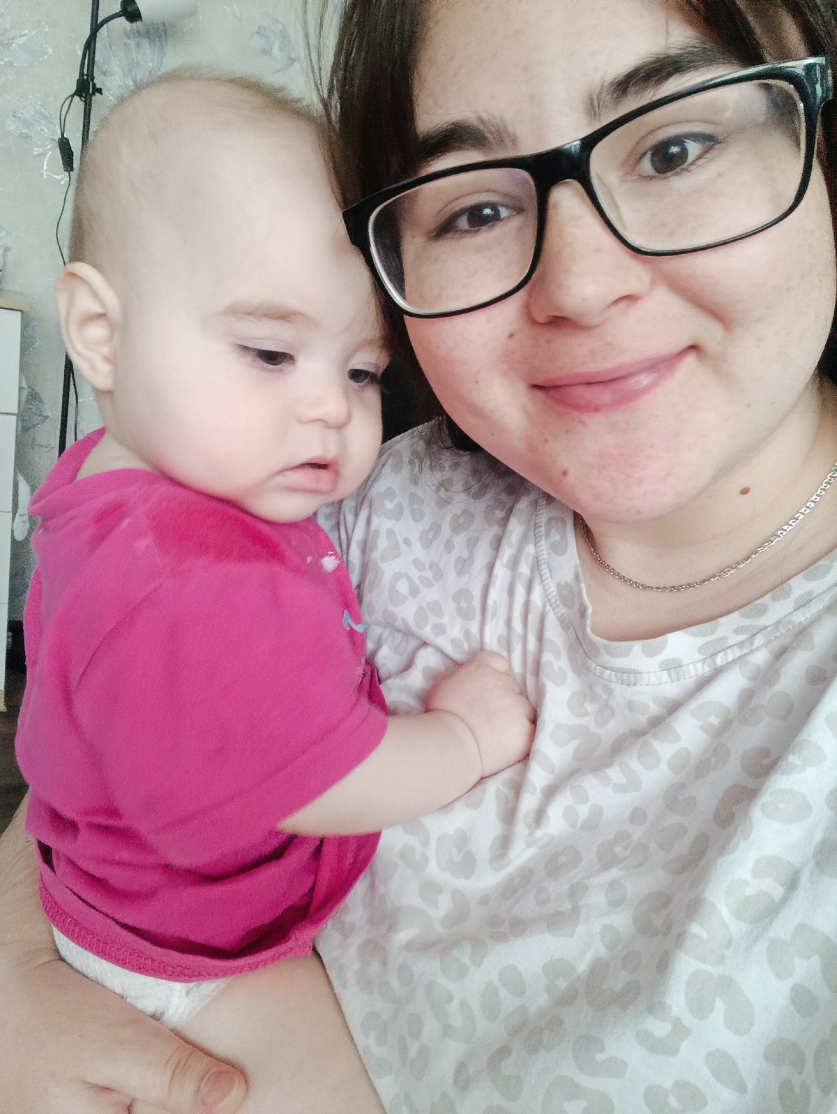 Woman and infant photographed in tender moment, Noviy Russia