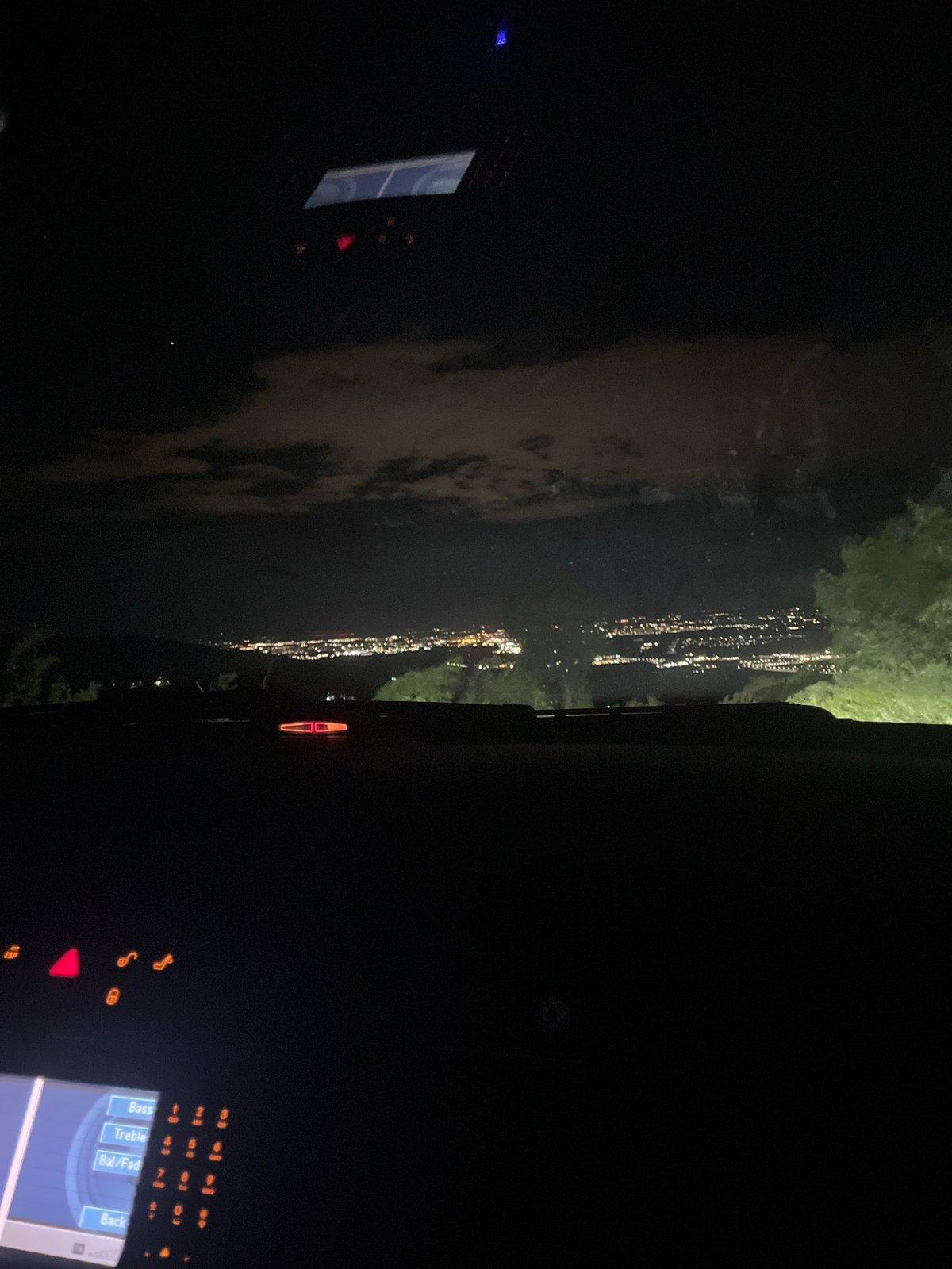 Nighttime city lights reflection captured from vehicle in Asenovgrad