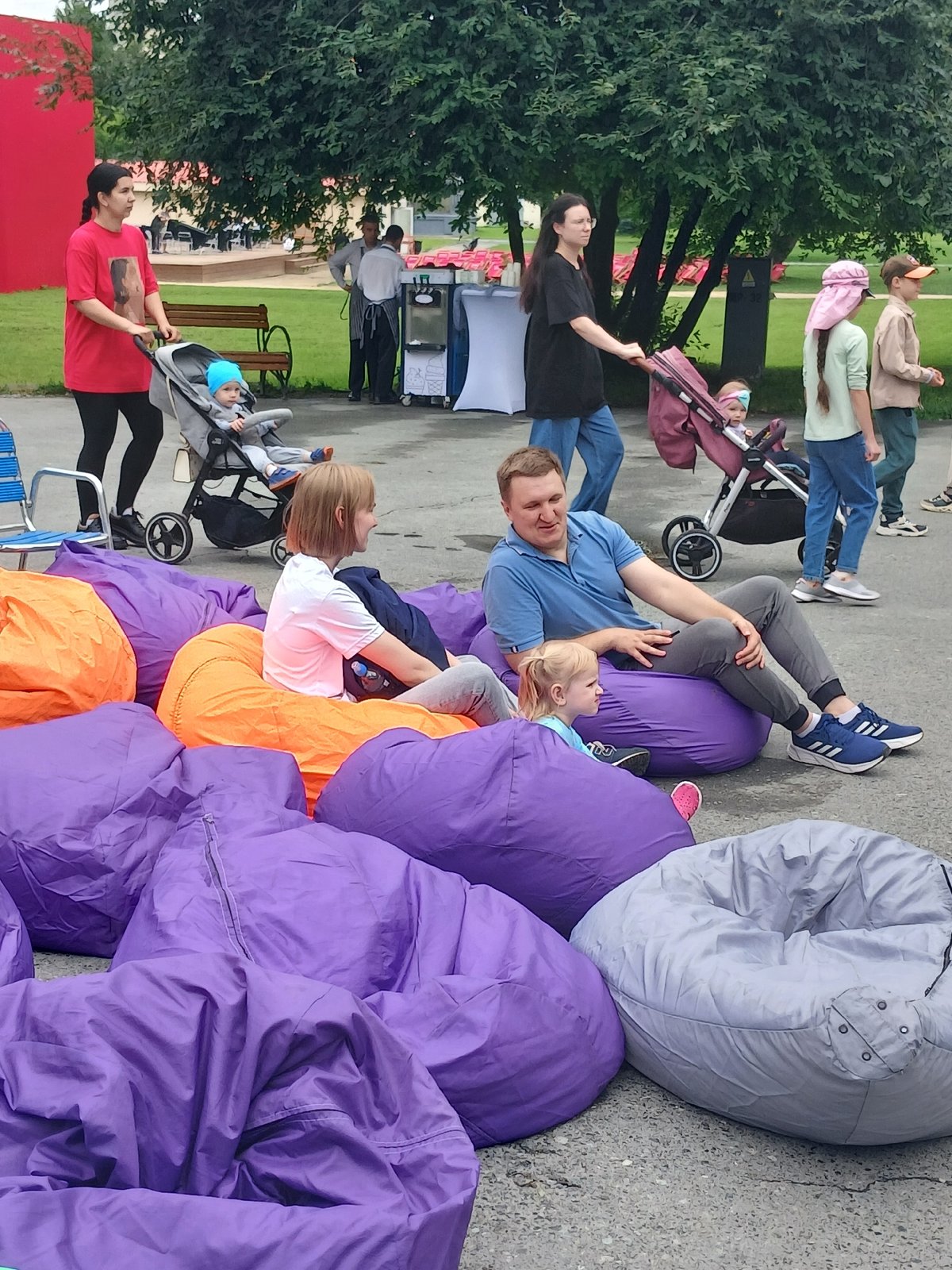 Outdoor public event with rides, seating, and mascots in Yekaterinburg
