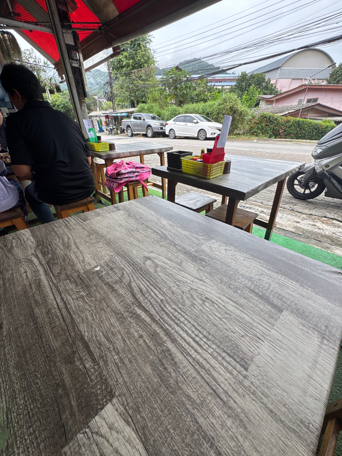 Drinks on a wooden table at a Kathu outdoor eatery