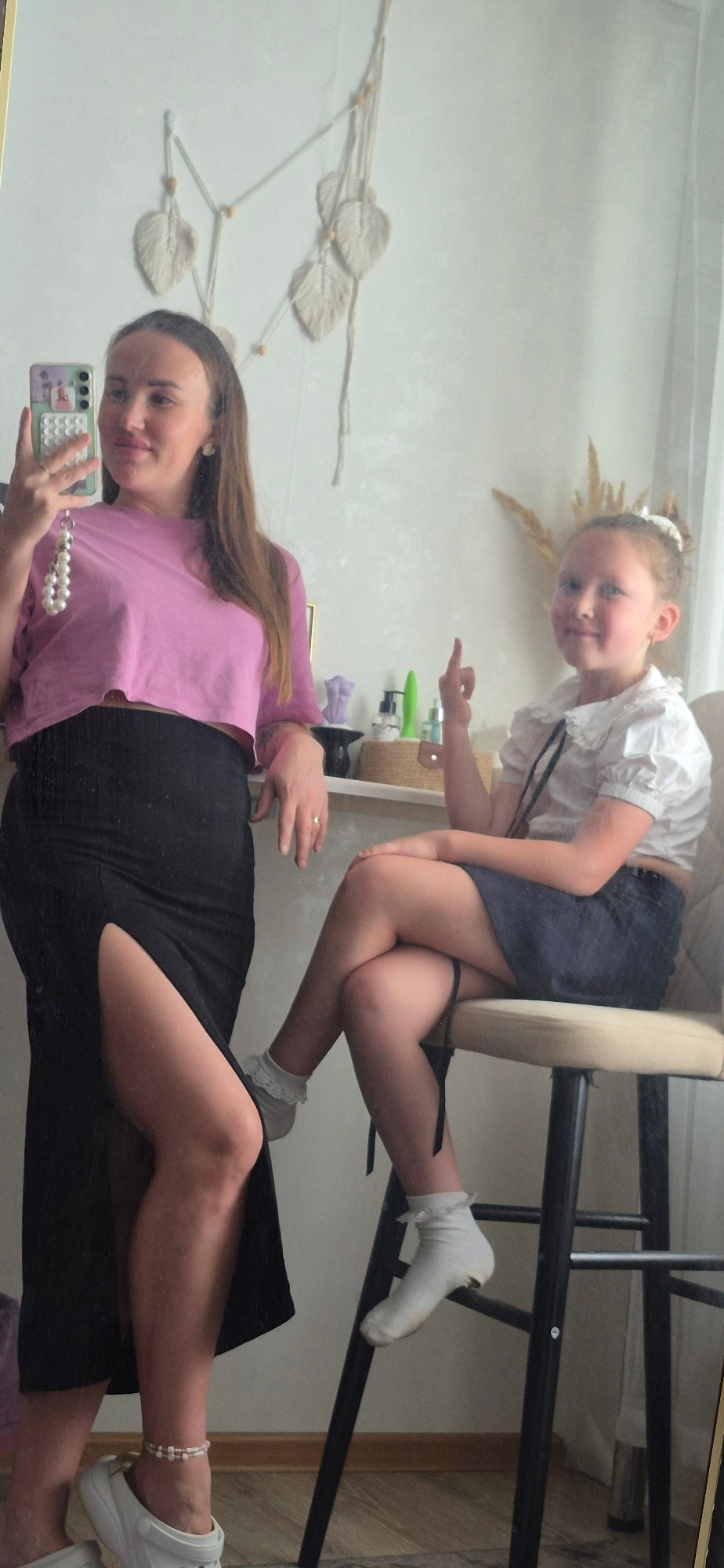 Woman takes selfie with child in mirror reflection