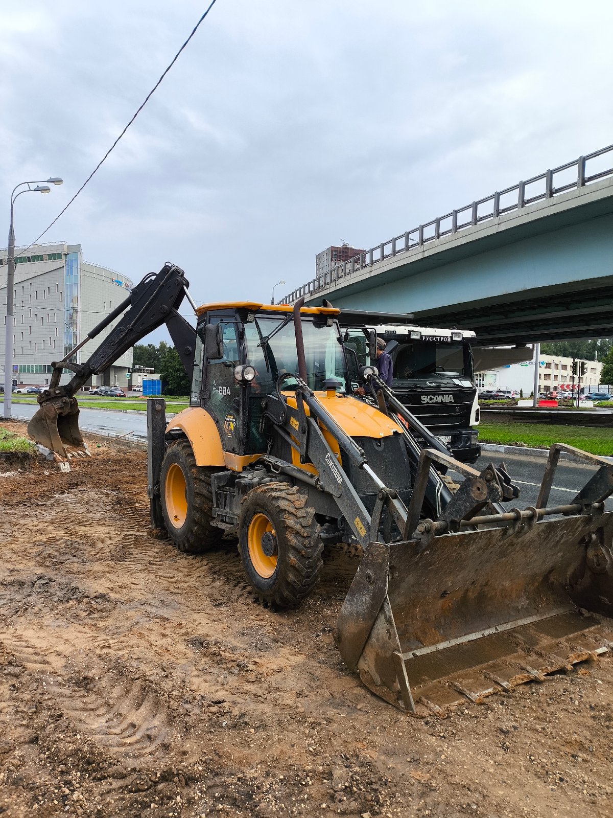 Rainy day park walk alongside active street construction