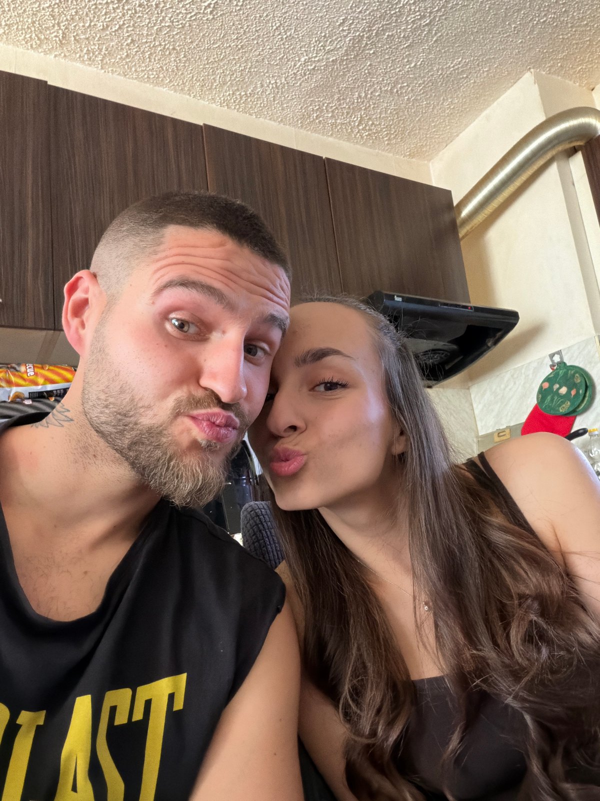 Couple photographs selfies together in Sofia kitchen setting