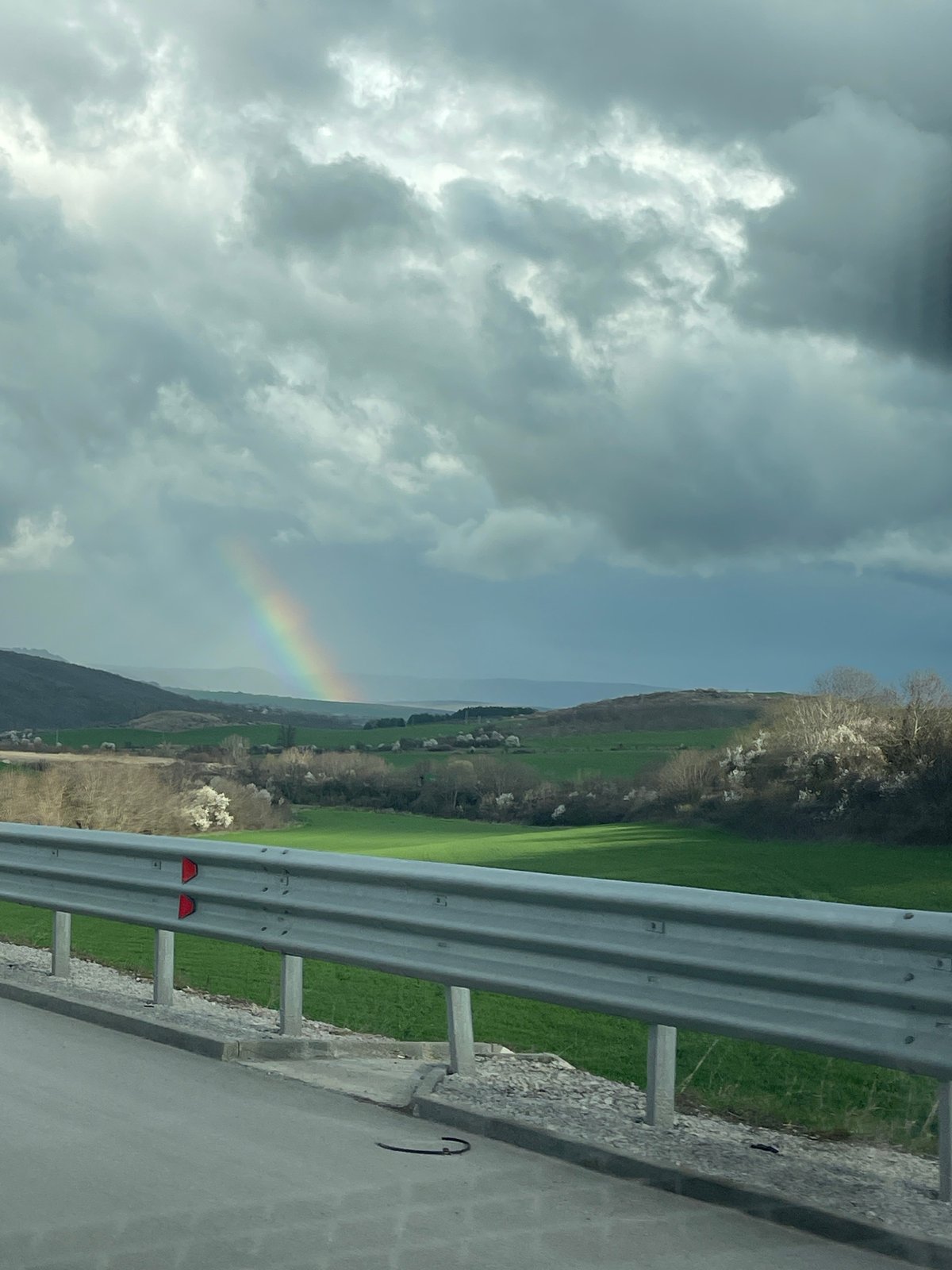 Rainbow appears over rural Bulgarian countryside near Buhovtsi