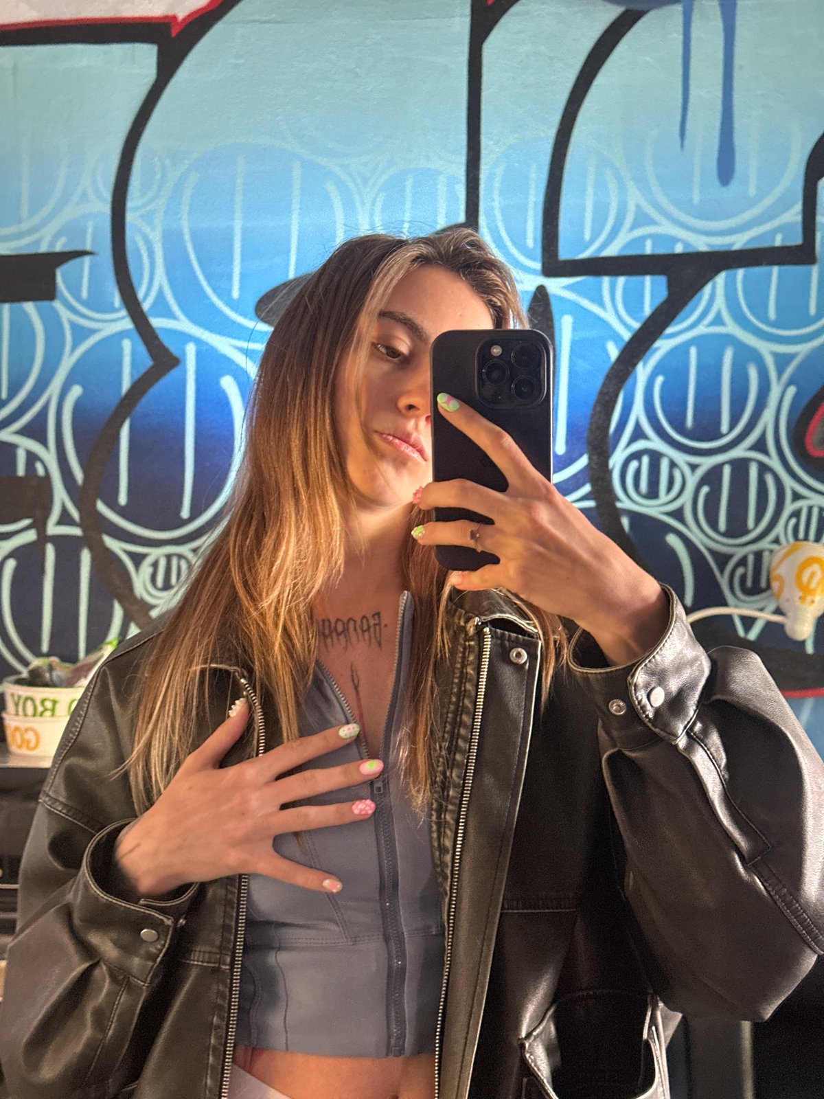 Selfies and street art details at a Moscow graffiti wall