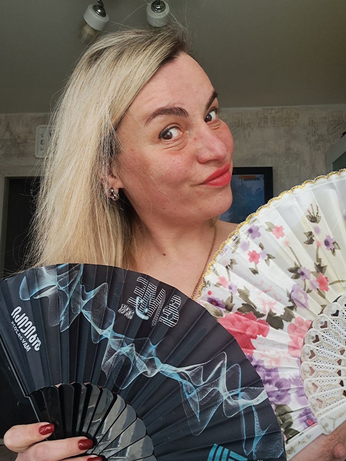 Woman displays decorative fans in Elektrostal, Russia
