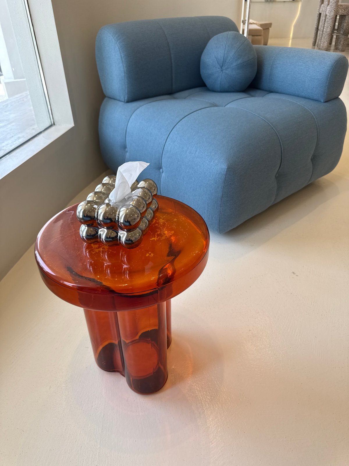 Contemporary interior space with orange glass object documented in Dubai