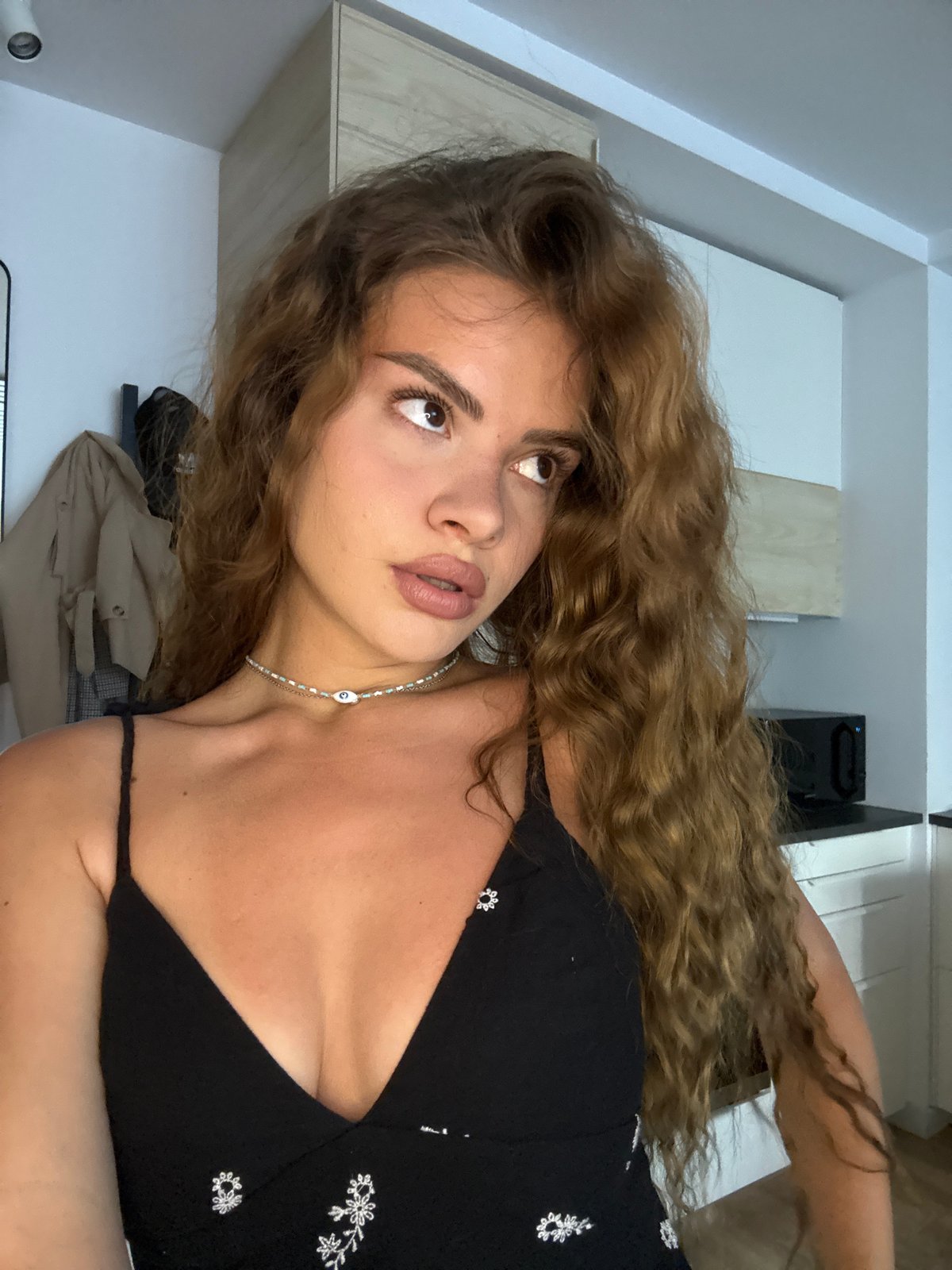 Woman documents morning routine through multiple indoor selfies