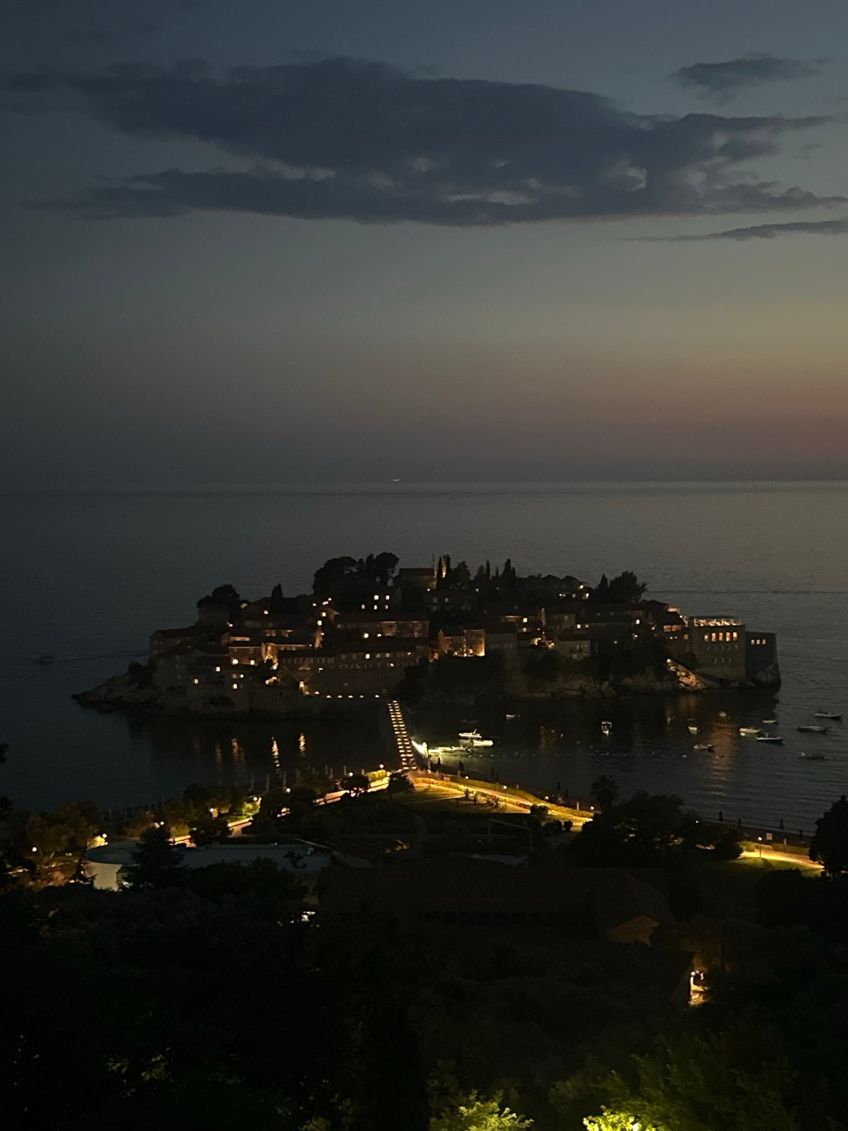 Sunset to nightfall over Sveti Stefan's illuminated island.