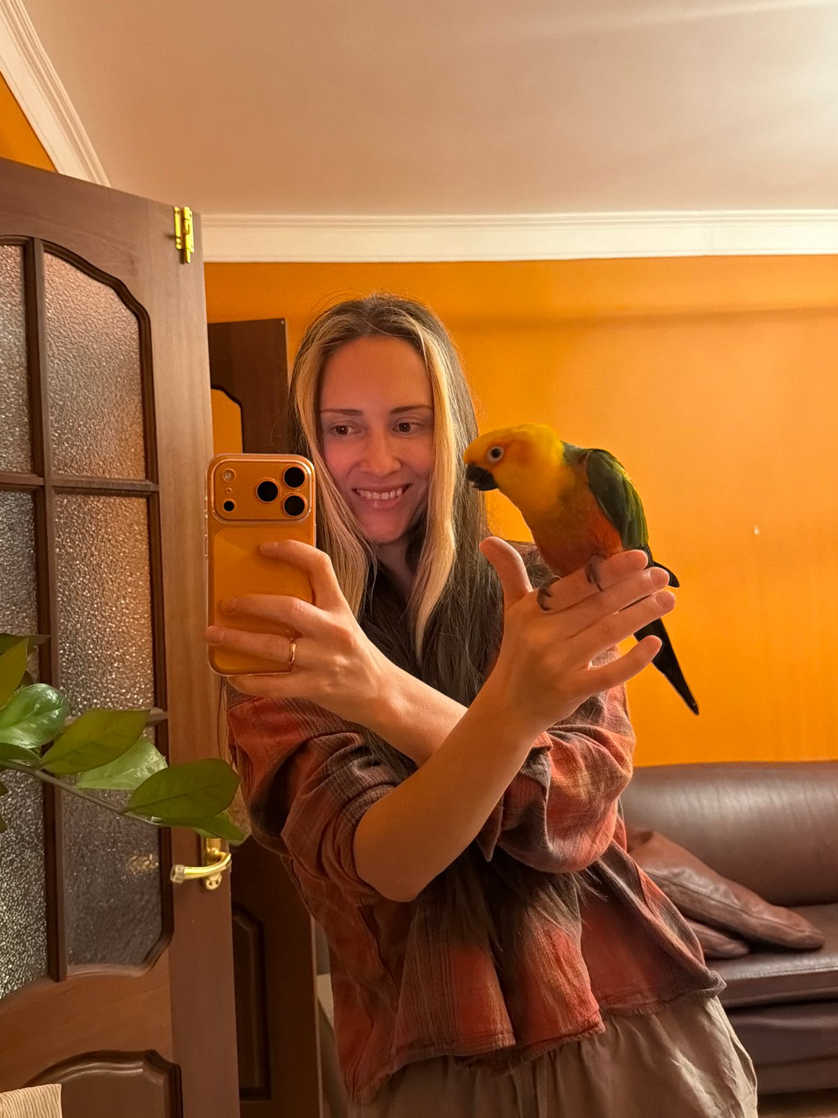 Woman poses with sun conure parrot in Khimki selfie
