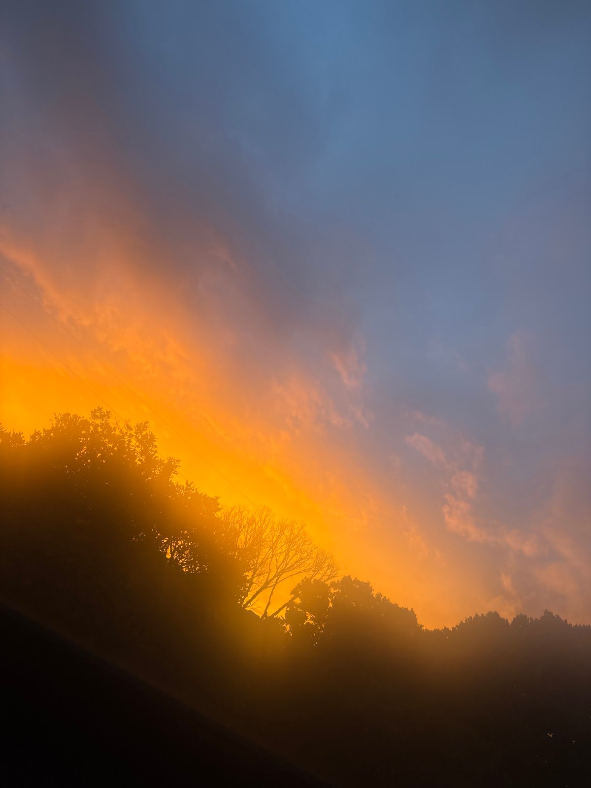 Sunset observed over Guarne, Colombia creates orange-blue sky display