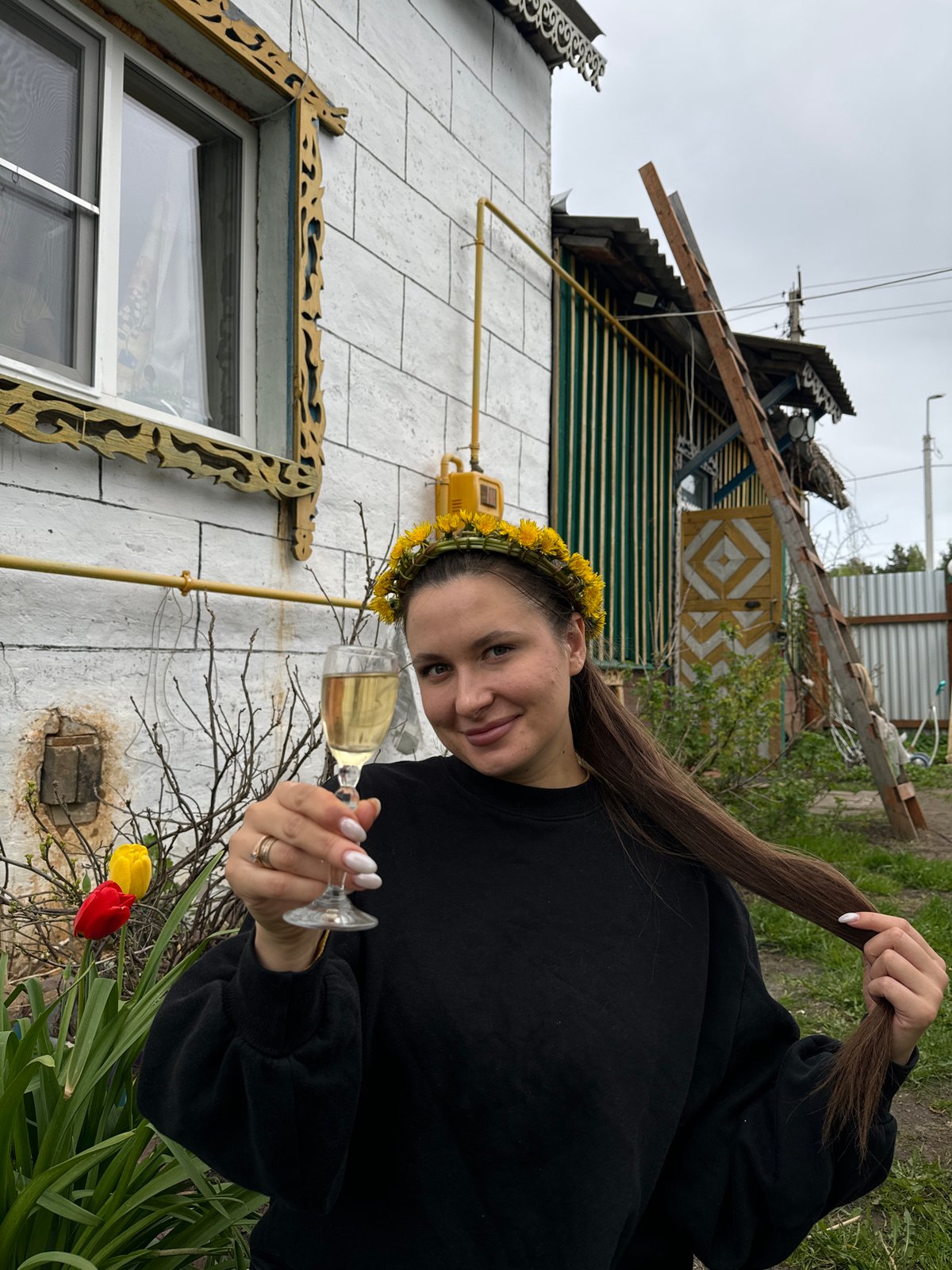 Woman in flower crown celebrates with champagne in Russian village