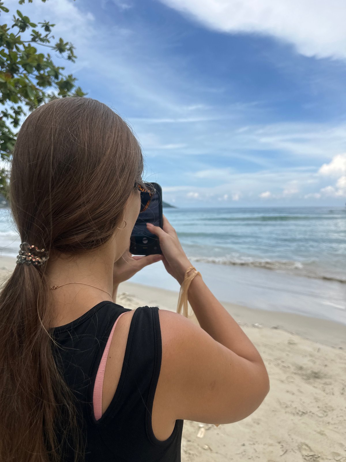 Coffee and phone in hand on Karon Beach