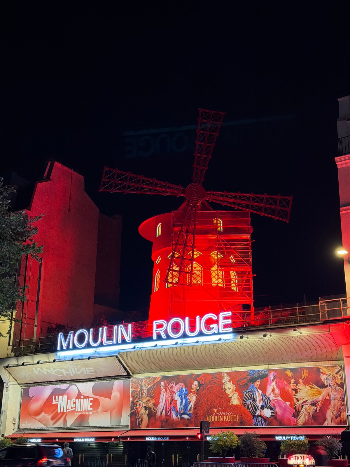 Moulin Rouge illuminated at night in Paris